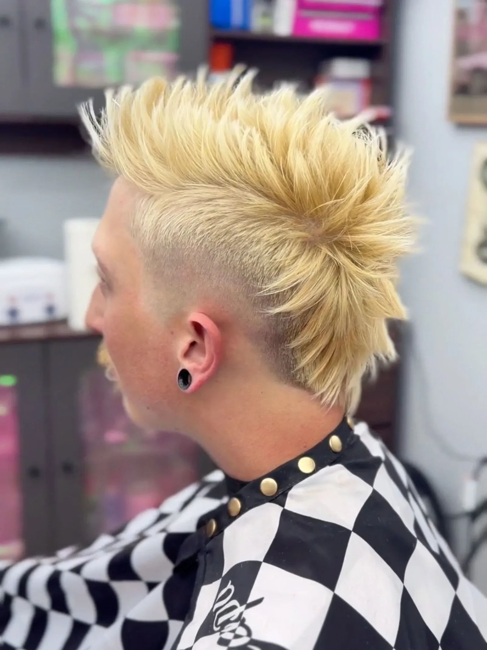 Side profile of a platinum blonde mohawk with high skin fade and spiked styling by Brandi Gross at The Panic Room, an alternative barbershop in Rapid City SD.