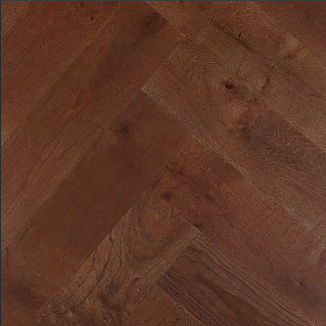Close-up of wooden floorboards with a reddish-brown stain, showing wood grain and knots.
