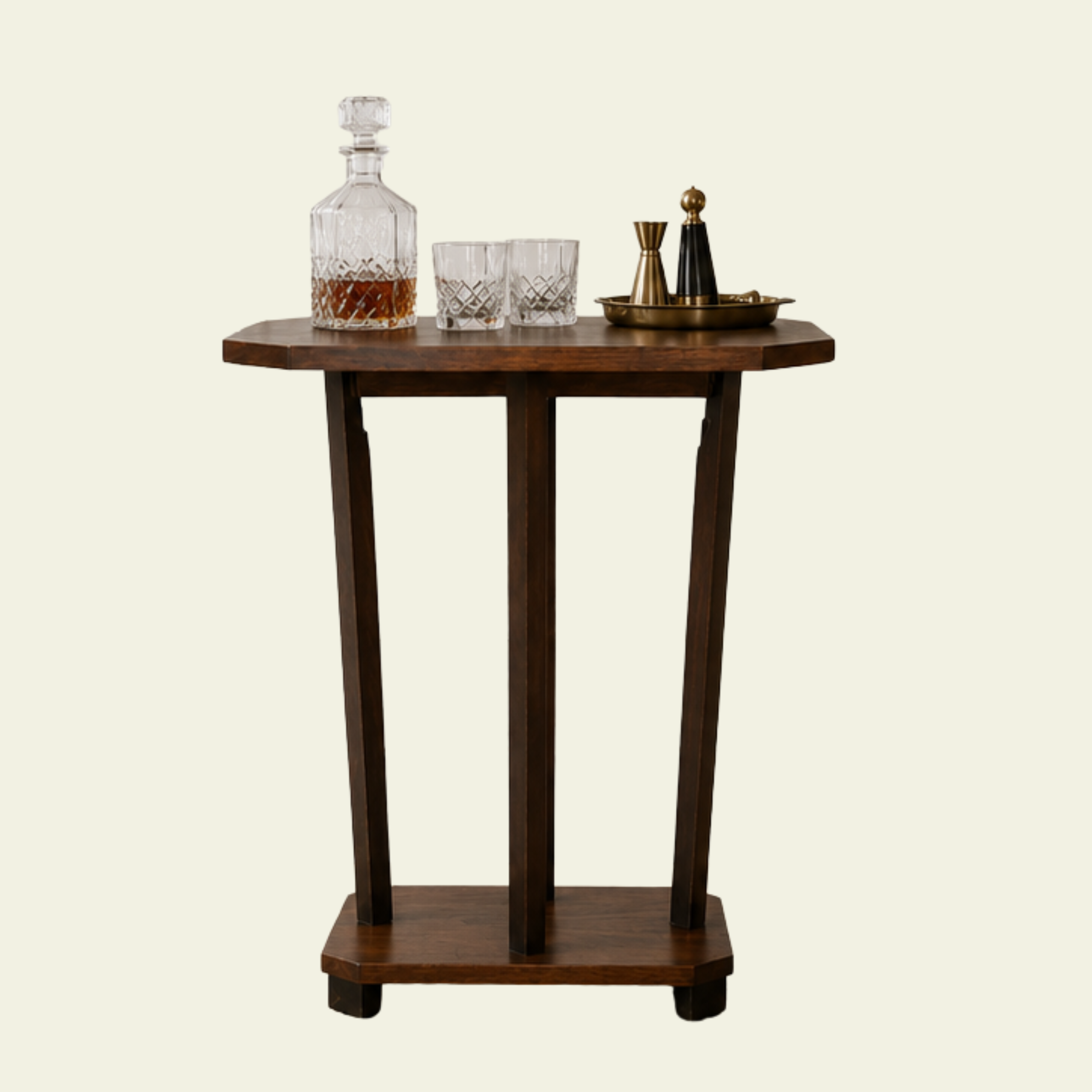 French art deco style wooden bar side table with a decanter and two glasses, along with a brass planter, all set against a plain light background.