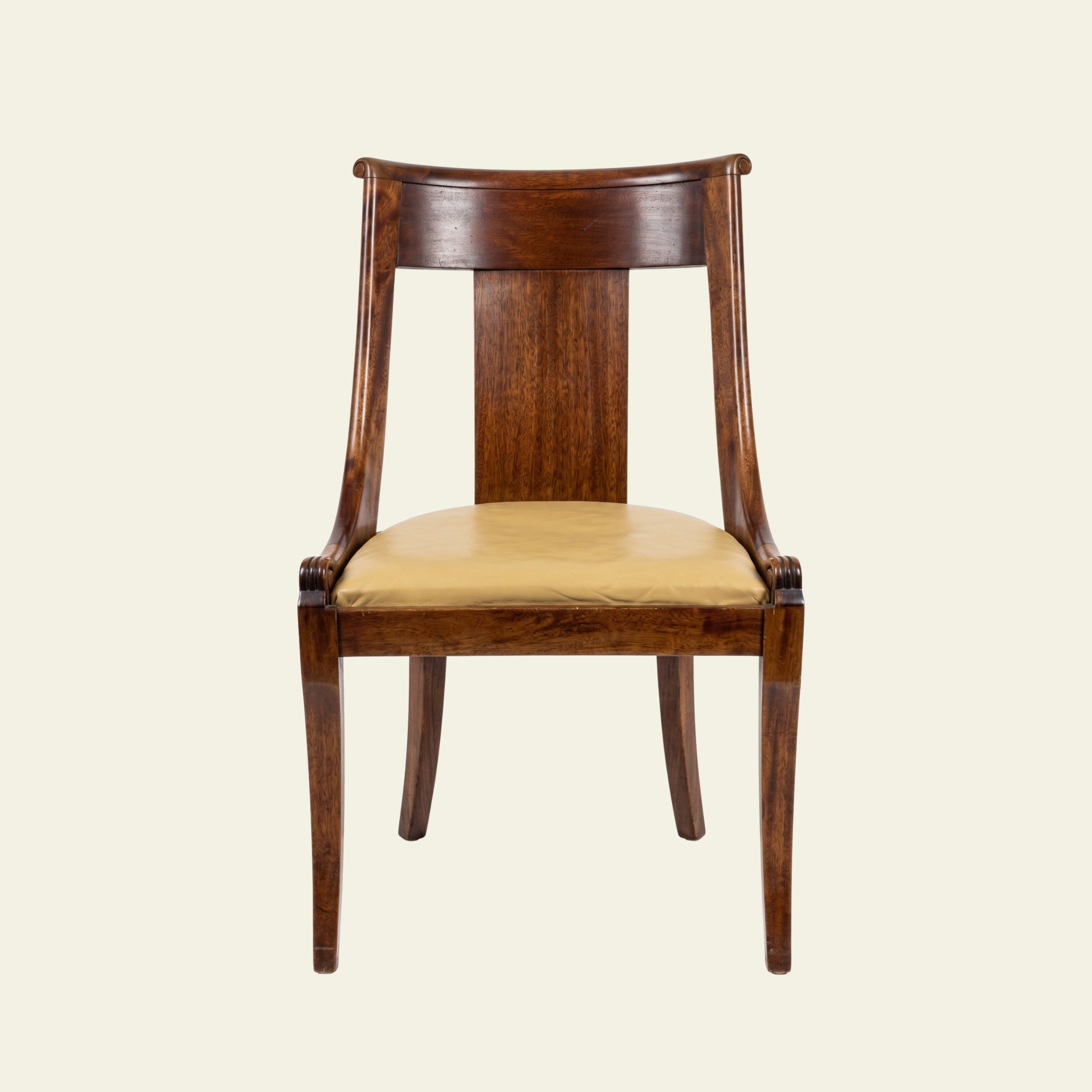 A wooden chair with a curved backrest and a beige cushioned seat.