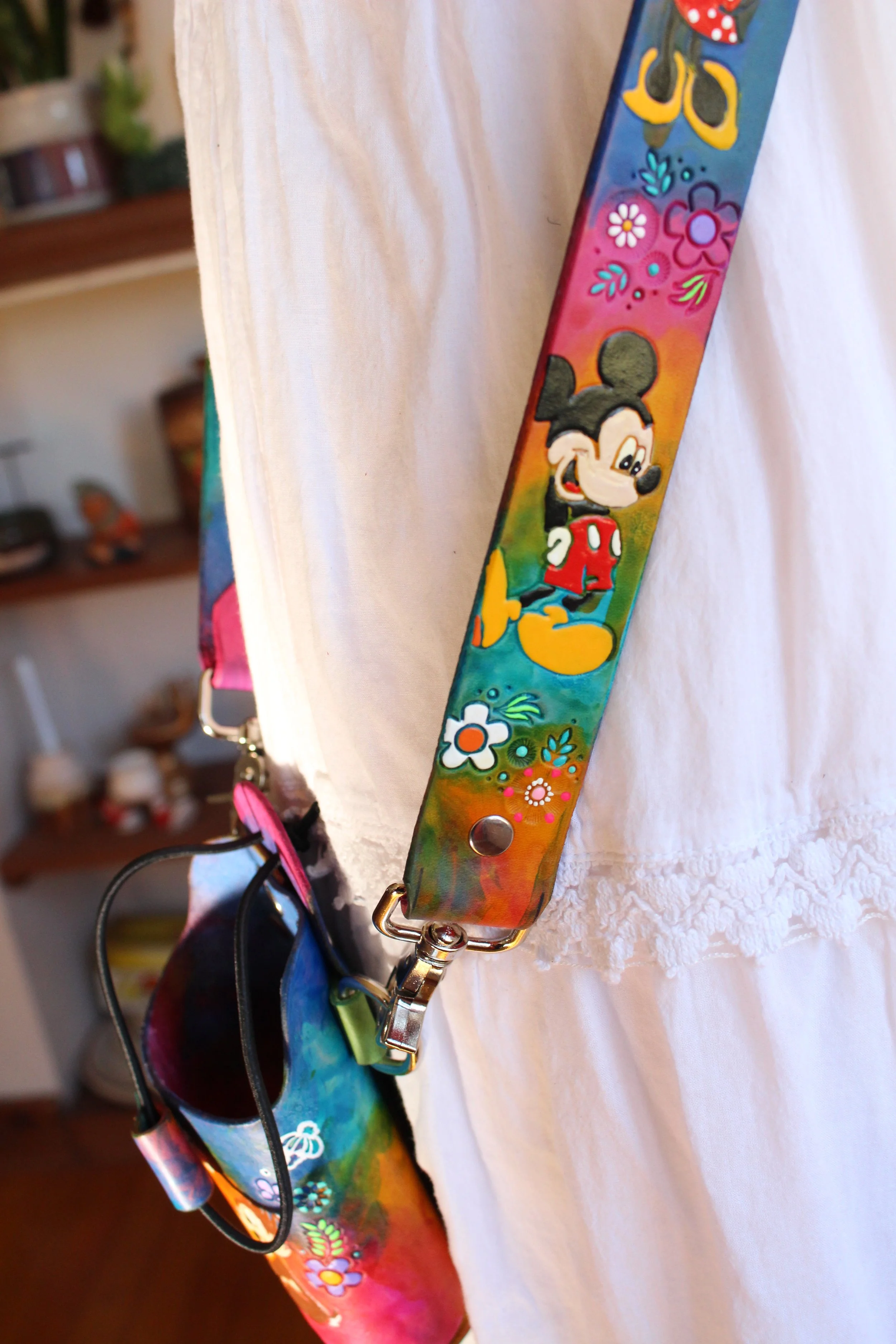 a crossbody fire radio leather strap with a rainbow stain effect in vibrant colors.