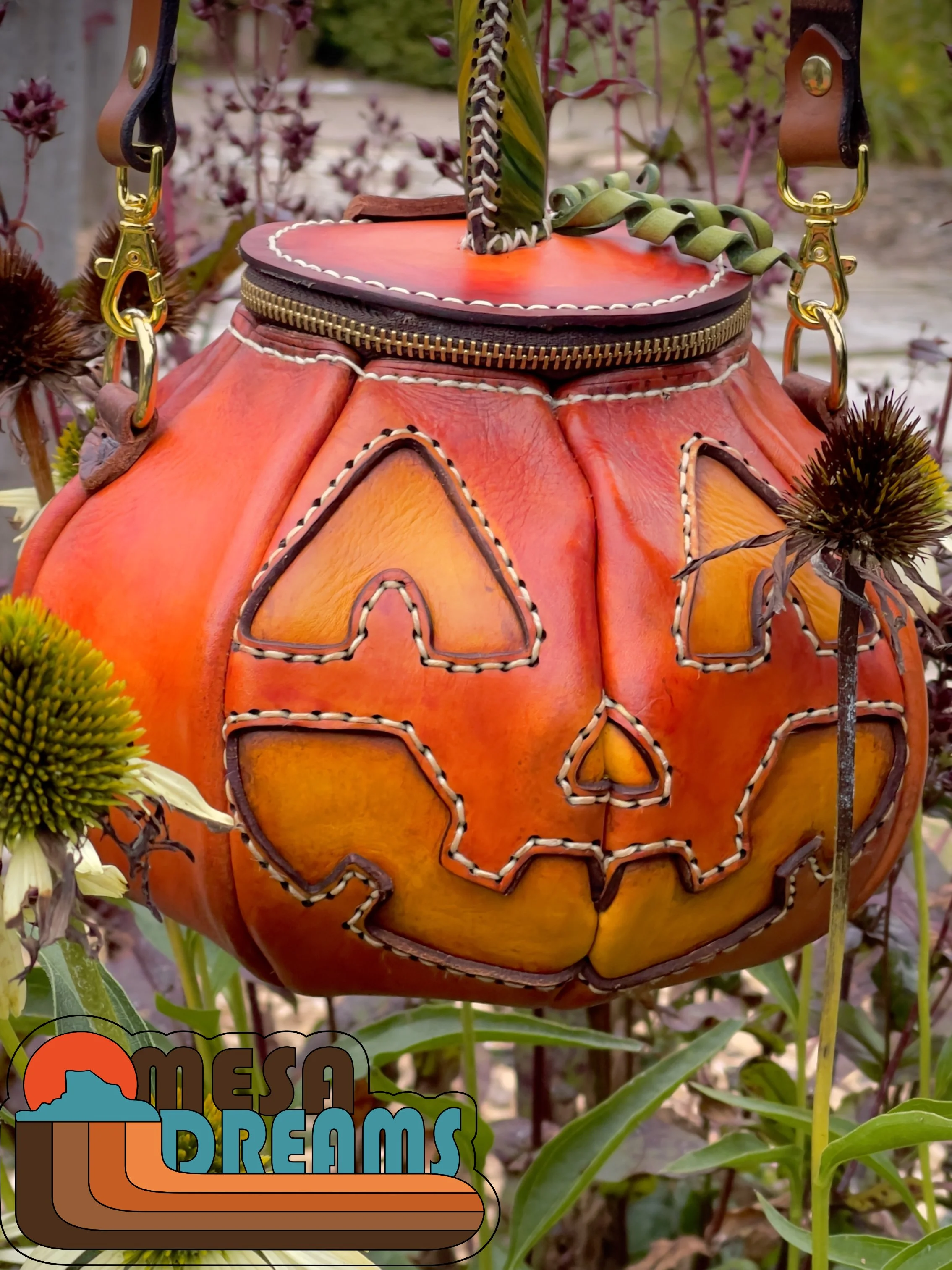 The Great Pumpkin bag hanging in a garden in autumn with rustic colors and flowers around it