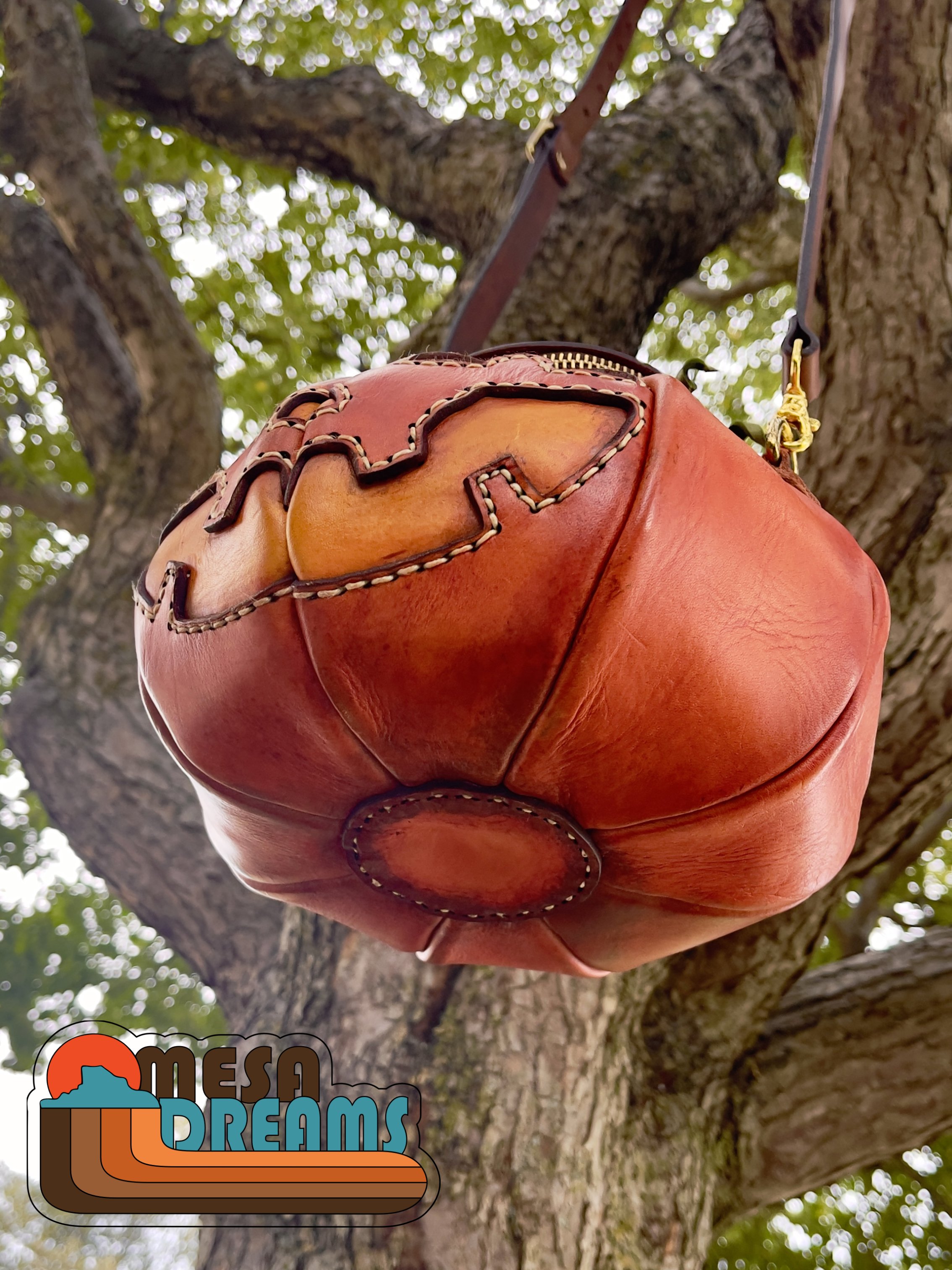 A view of the underside of the Great Pumpkin leather bag highlighting the stitching and pumpkin shape.