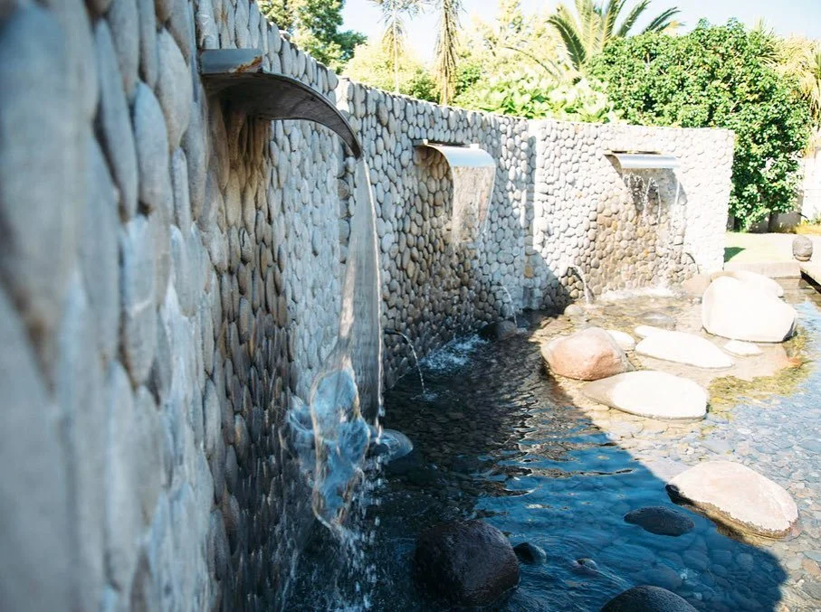 Beautiful stone water feature with a wooden bridge gives wow factor in this contemporary garden 💦