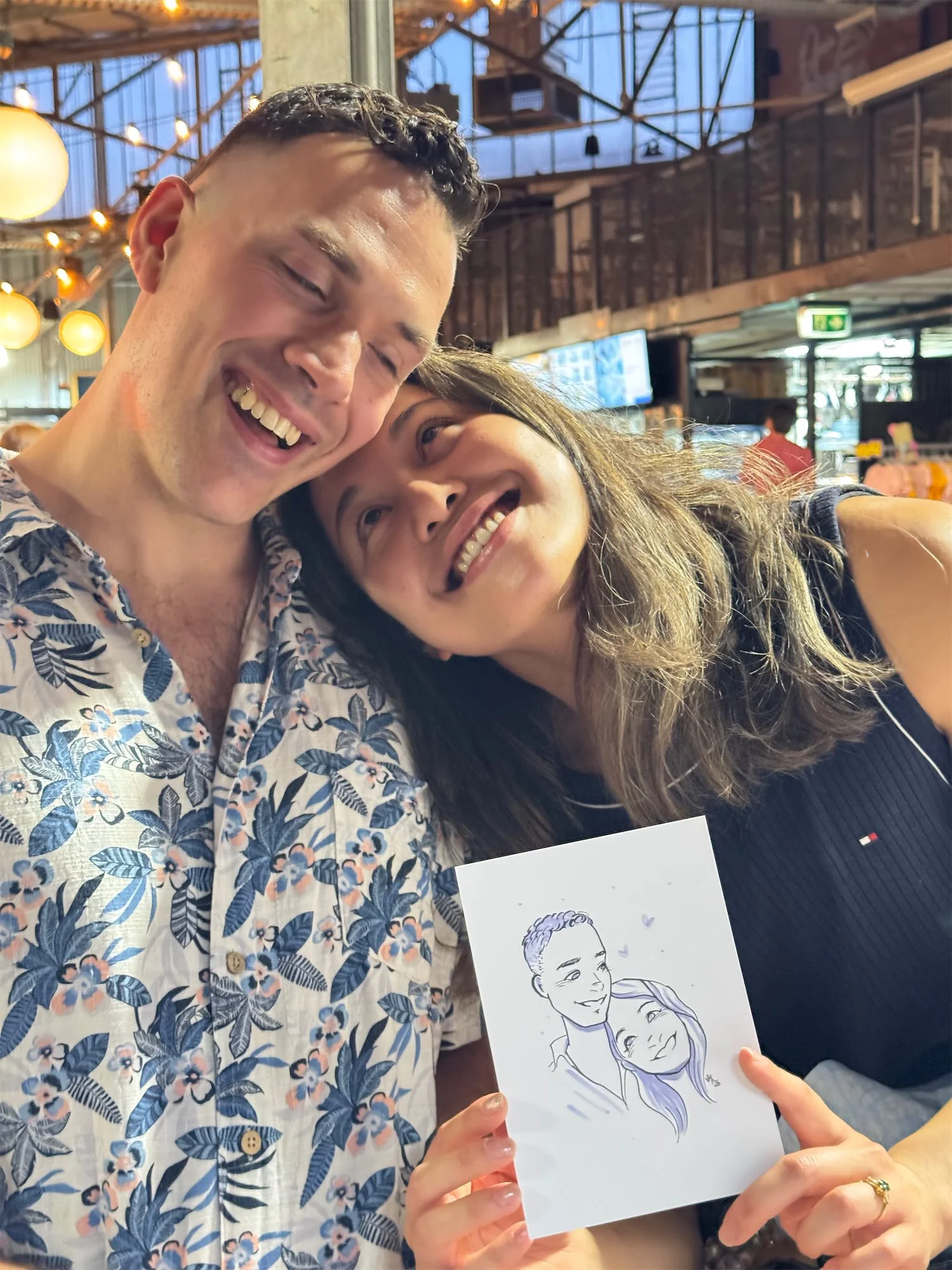 A couple posing with their live event portrait