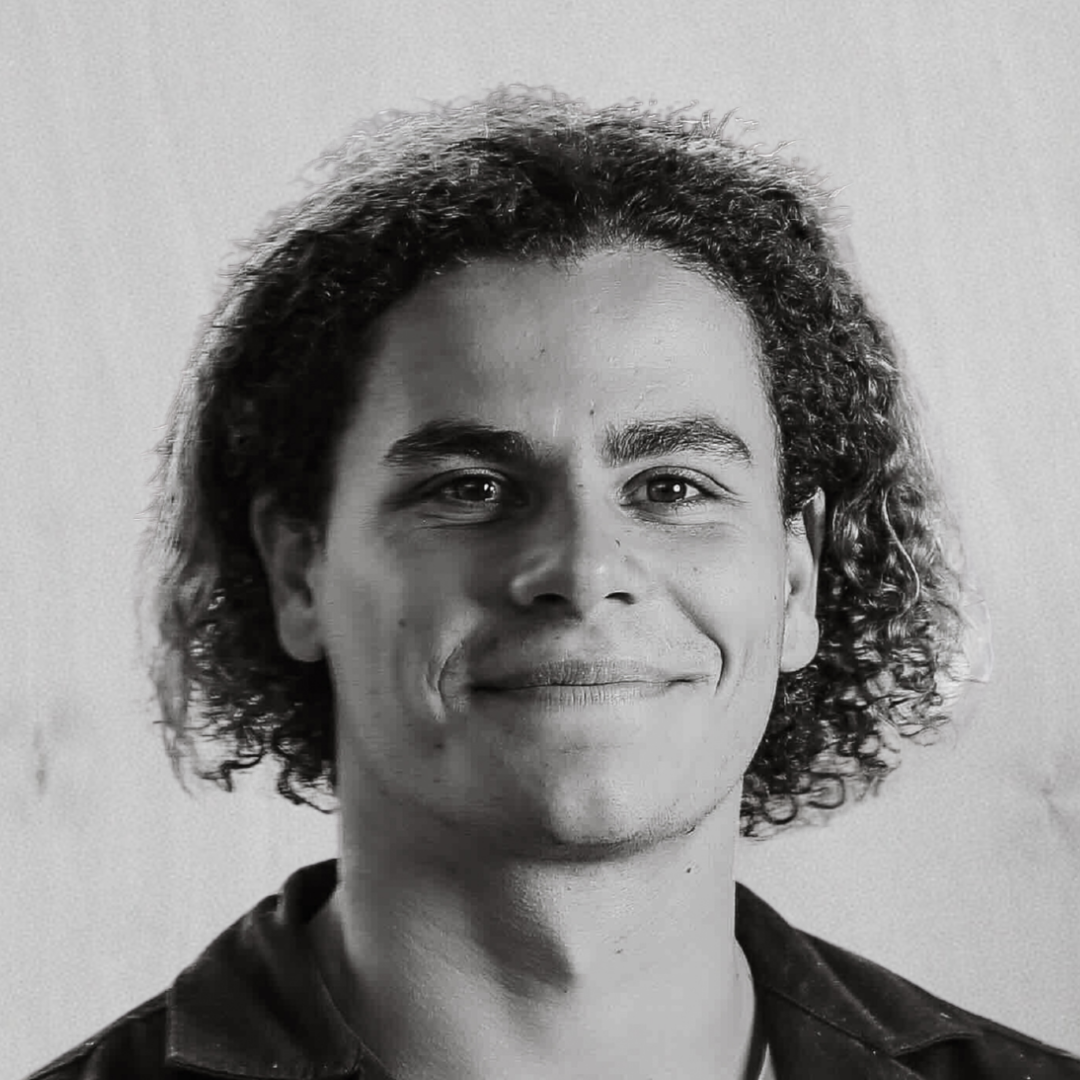 Black and white portrait of RHYS WARREN. Production Lead at BRANDID MEDIA GROUP