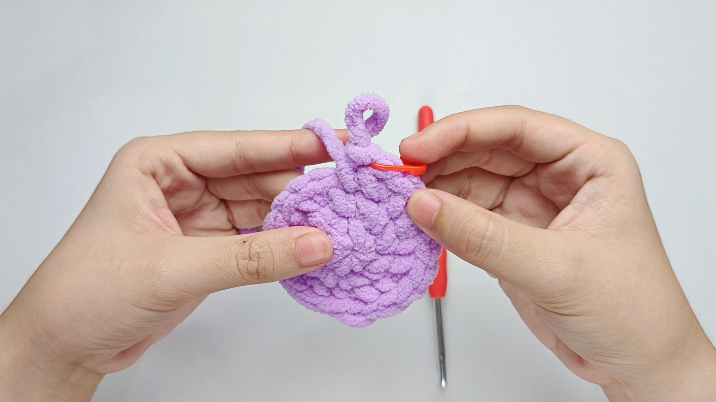Mark the first stitch: Remove your hook for a moment, and use the stitch marker to mark this first stitch.