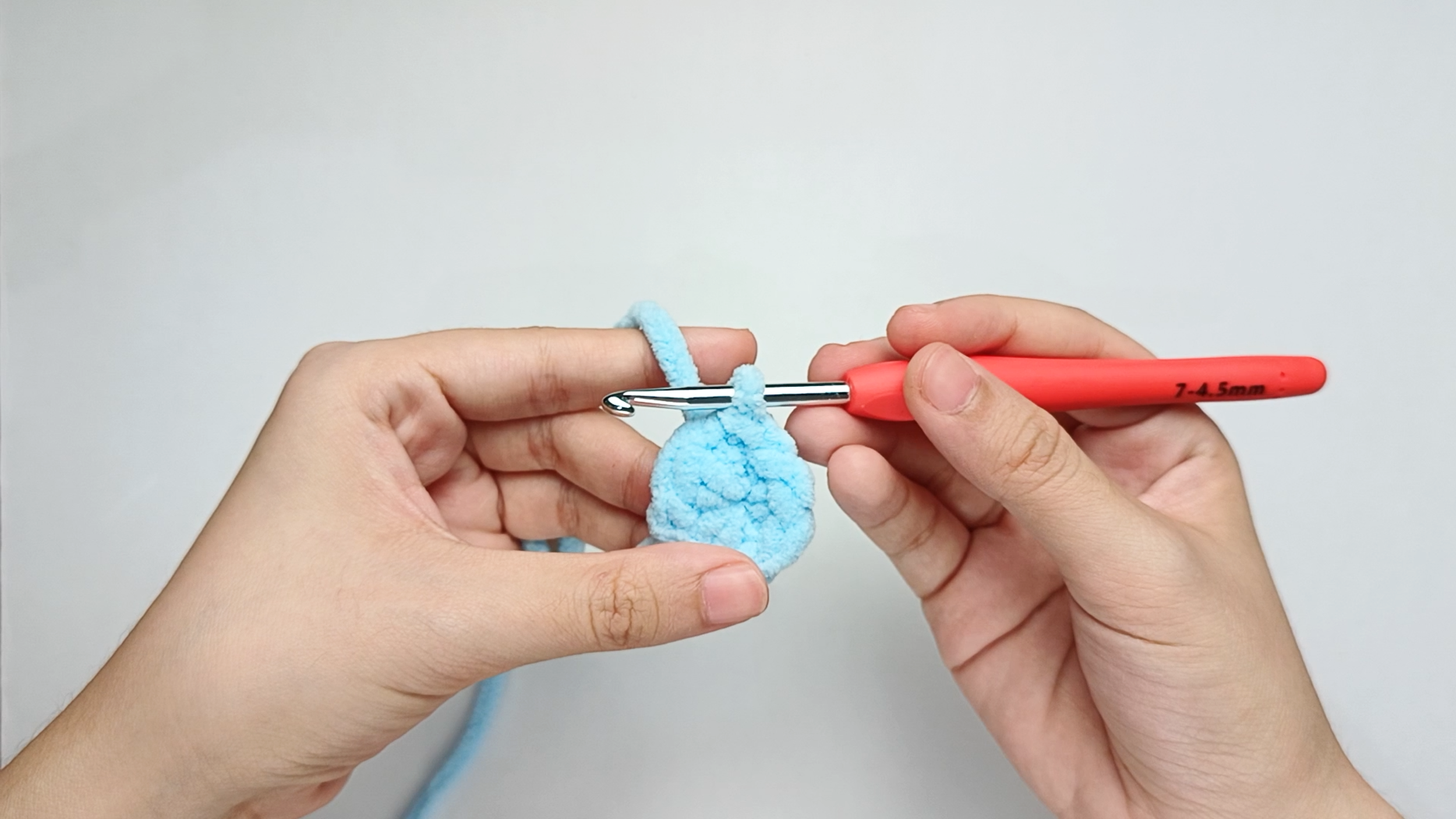 Make a slip stitch (sl st): Yarn over, then pull the yarn through the stitch and the loop on your hook.