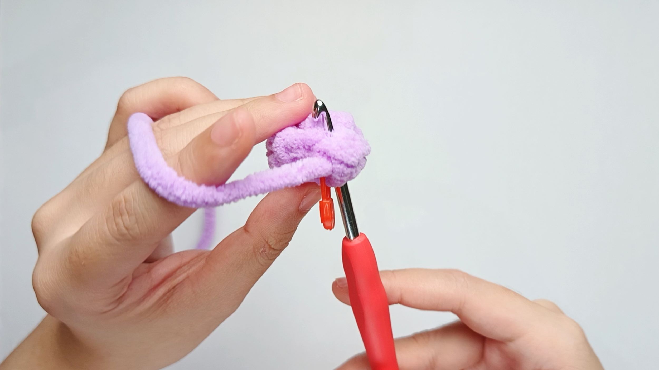 Hook back in: Insert your hook through both stitches (the first and last). Remove the stitch marker so the stitch is easier to work into.