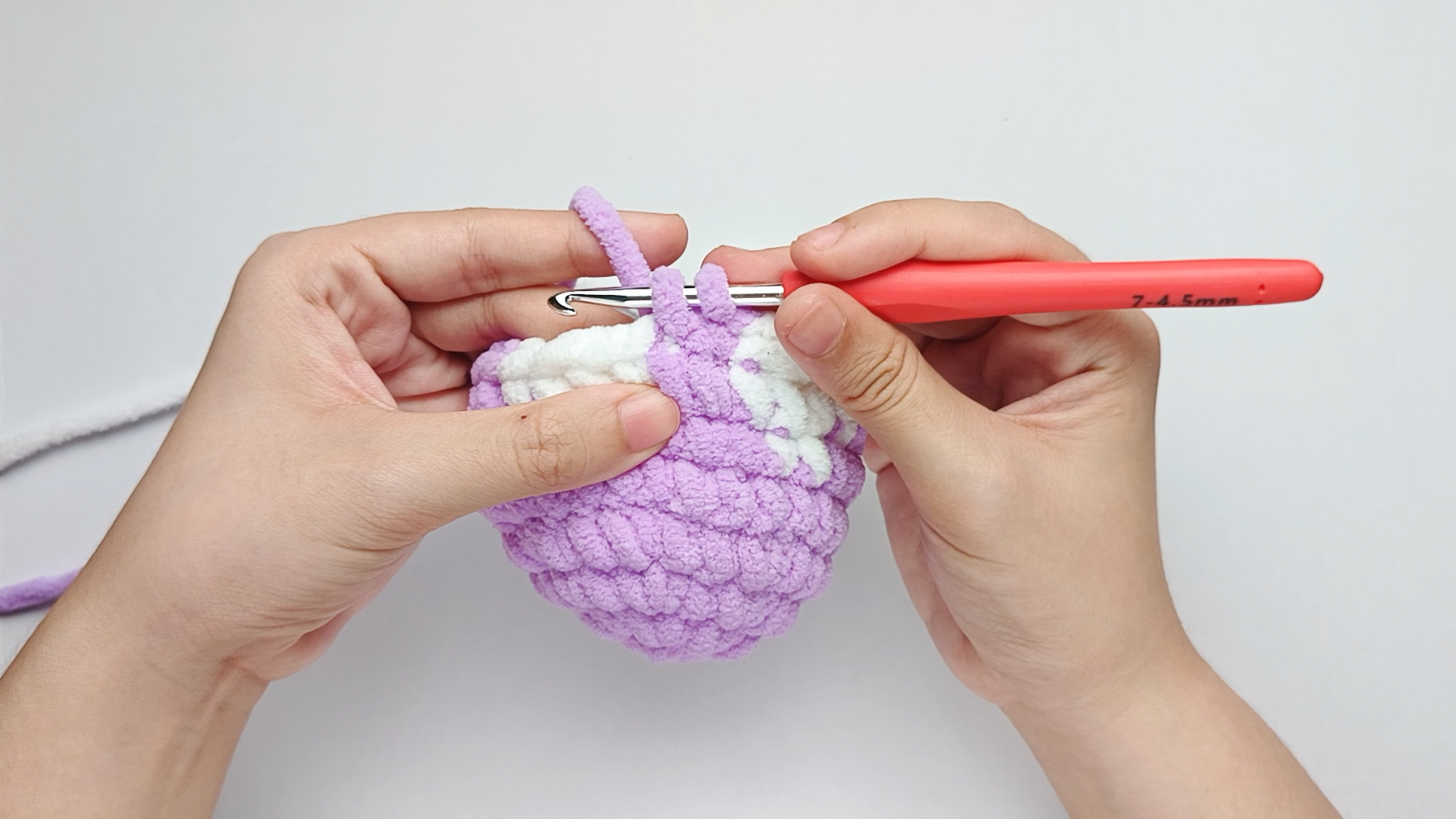 Make 2 purple single crochets (sc): Color change to purple, make 2 purple single crochets (sc), and stop just before the final yarn over.
