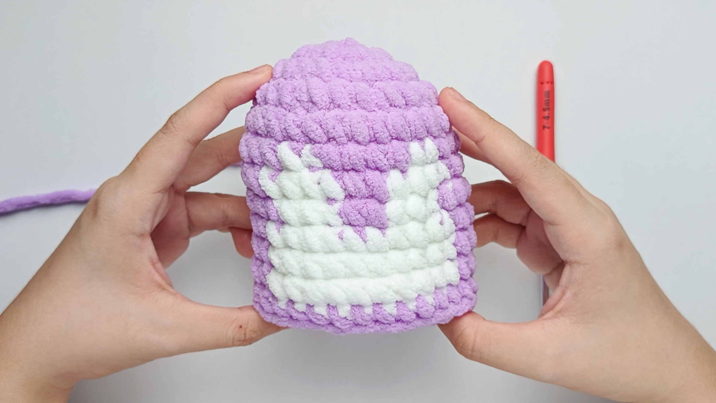 Completed Round 12: Here, we have made 1 purple single crochet (sc) in each stitch around. There should be 28 stitches in total.
