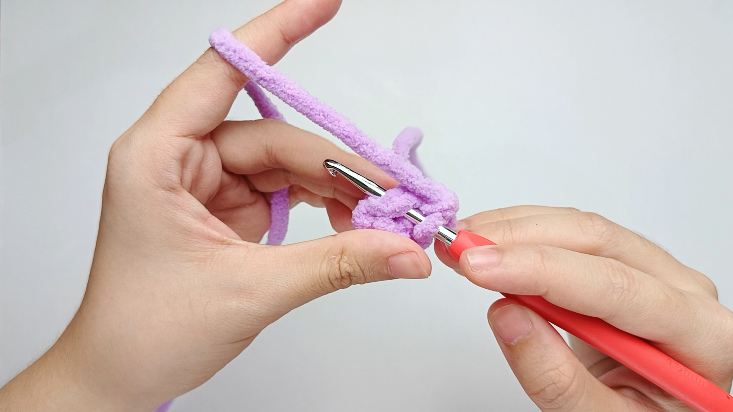 Hook back in: Insert your hook into that marked stitch to begin Round 3. Remove the stitch marker so the stitch is easier to work into.