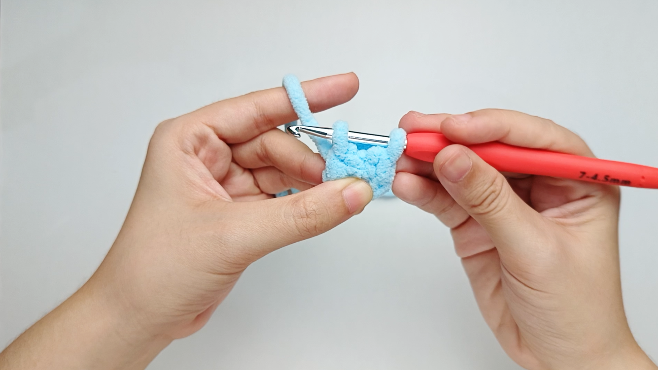 Pull through the stitch: Pull the yarn through the stitch. You should now have two loops on your hook.