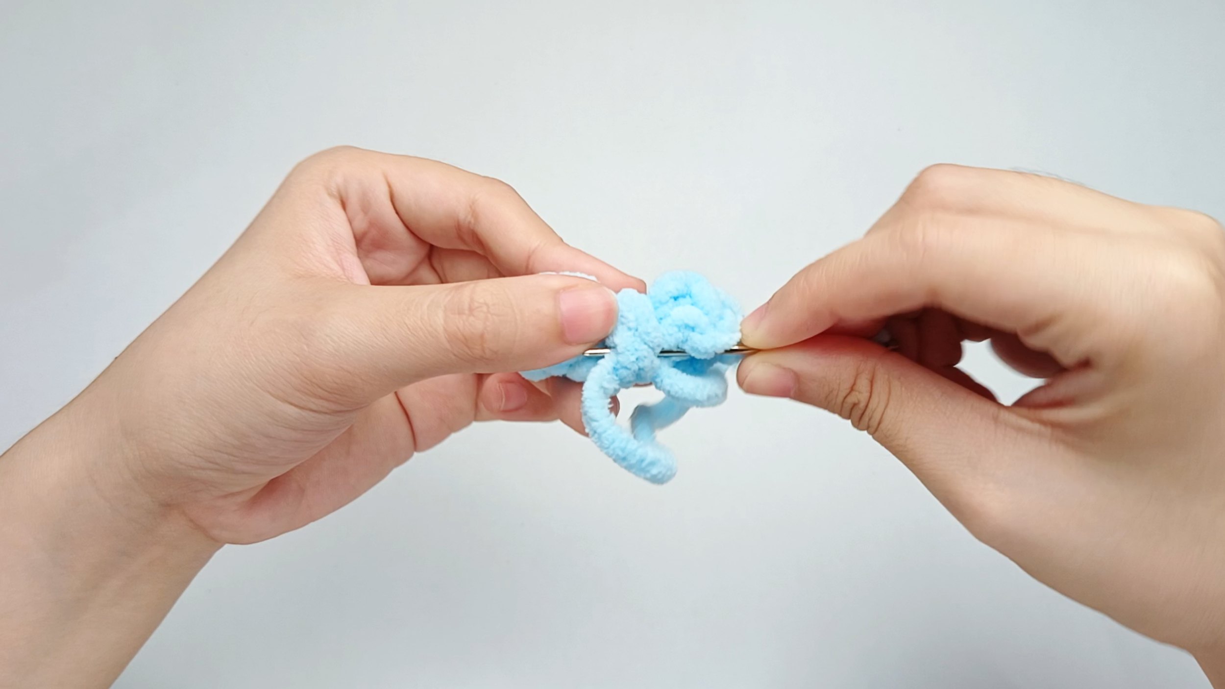 Secure it: Weave the tail through the center a couple of times to lock the shape. Keep this tail - you’ll use it to sew the Bow on later.
