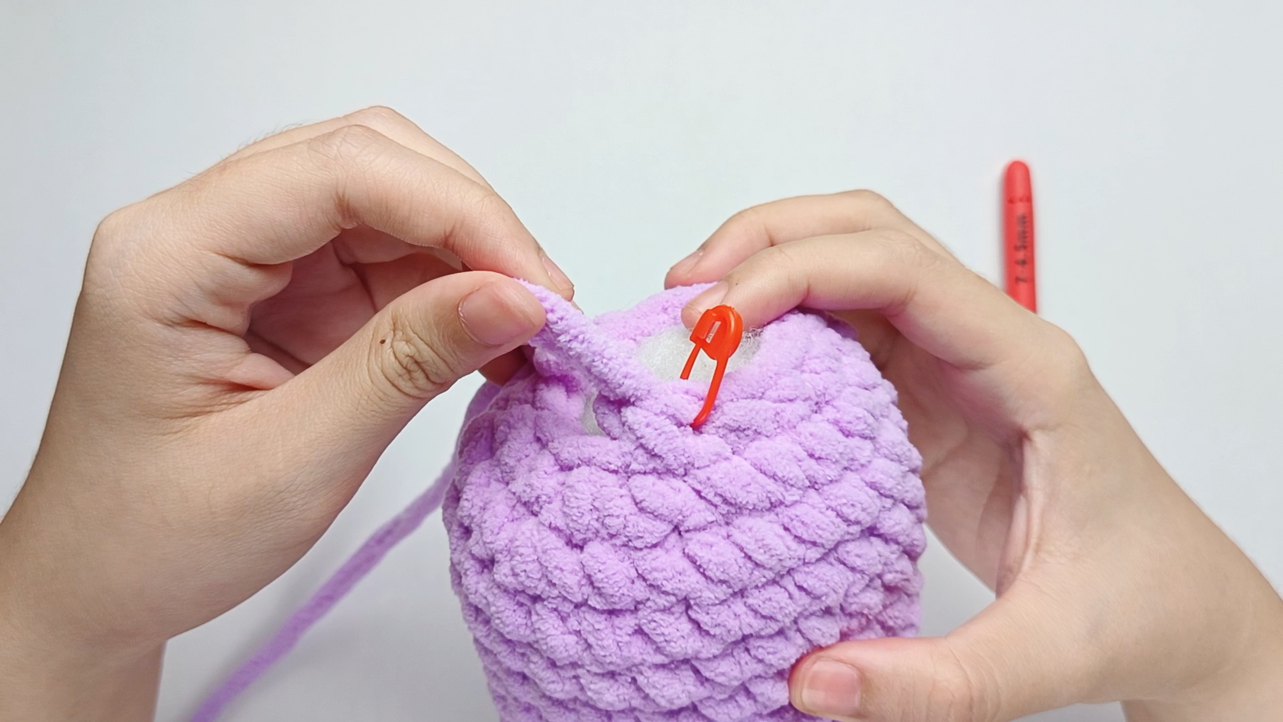 Mark the first stitch: Remove your hook for a moment, and use the stitch marker to mark this first stitch.
