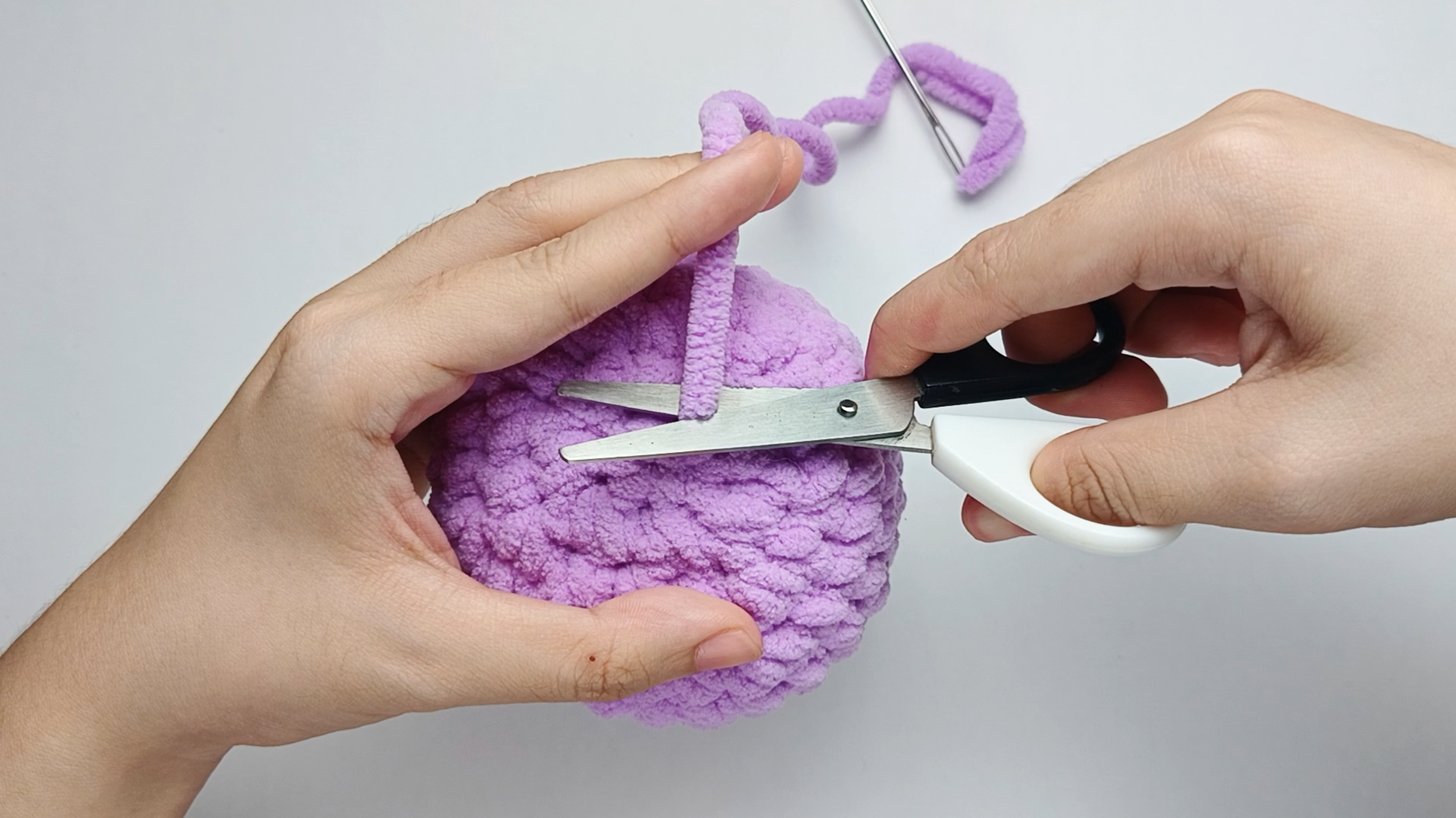Weave in and trim: Push the needle into the inside of the piece, through a few stitches, and pull through.