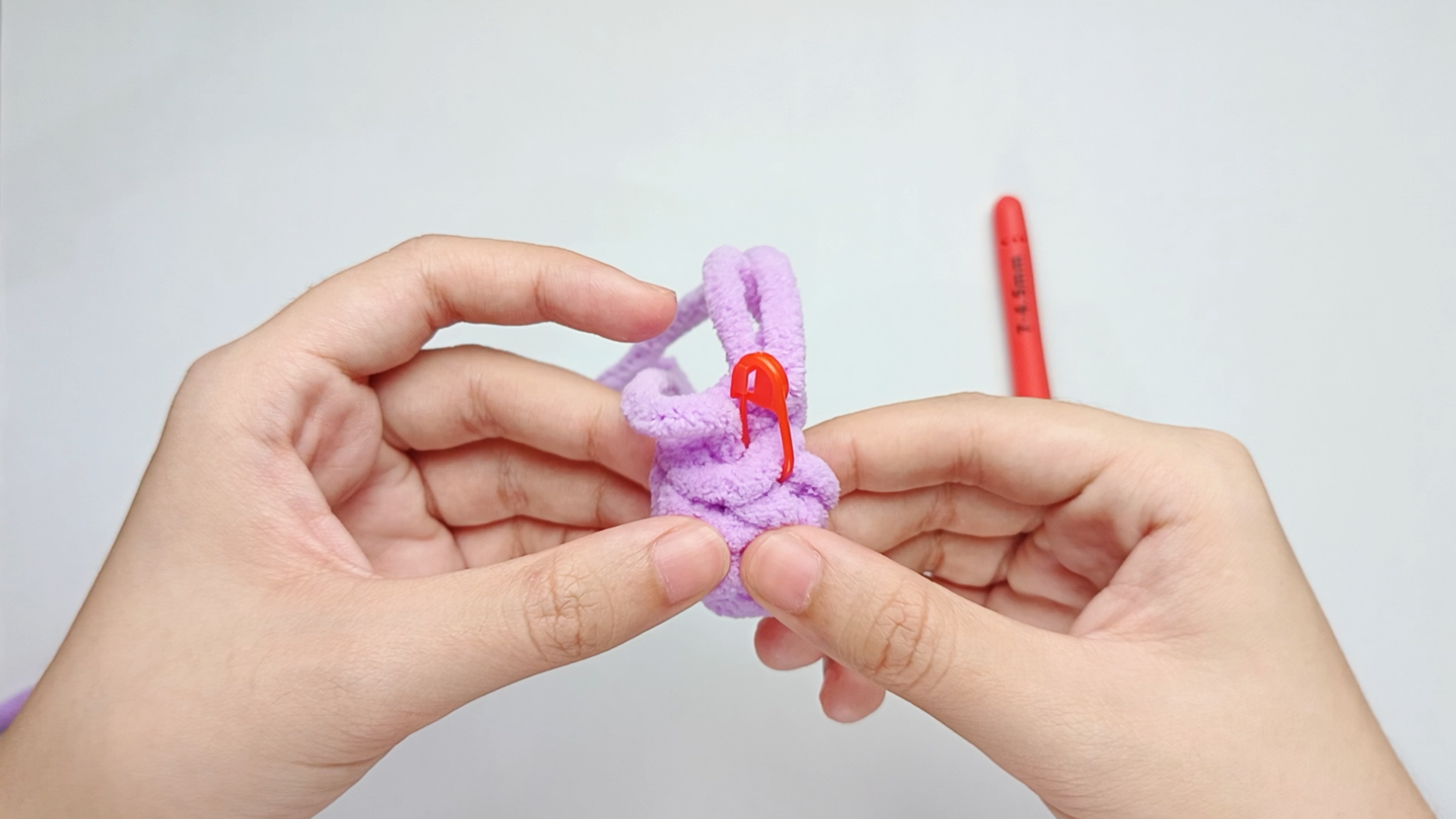 Fold the Wing: Gently fold the round Wing in half so the first stitch and the last stitch of the round are lined up next to each other.