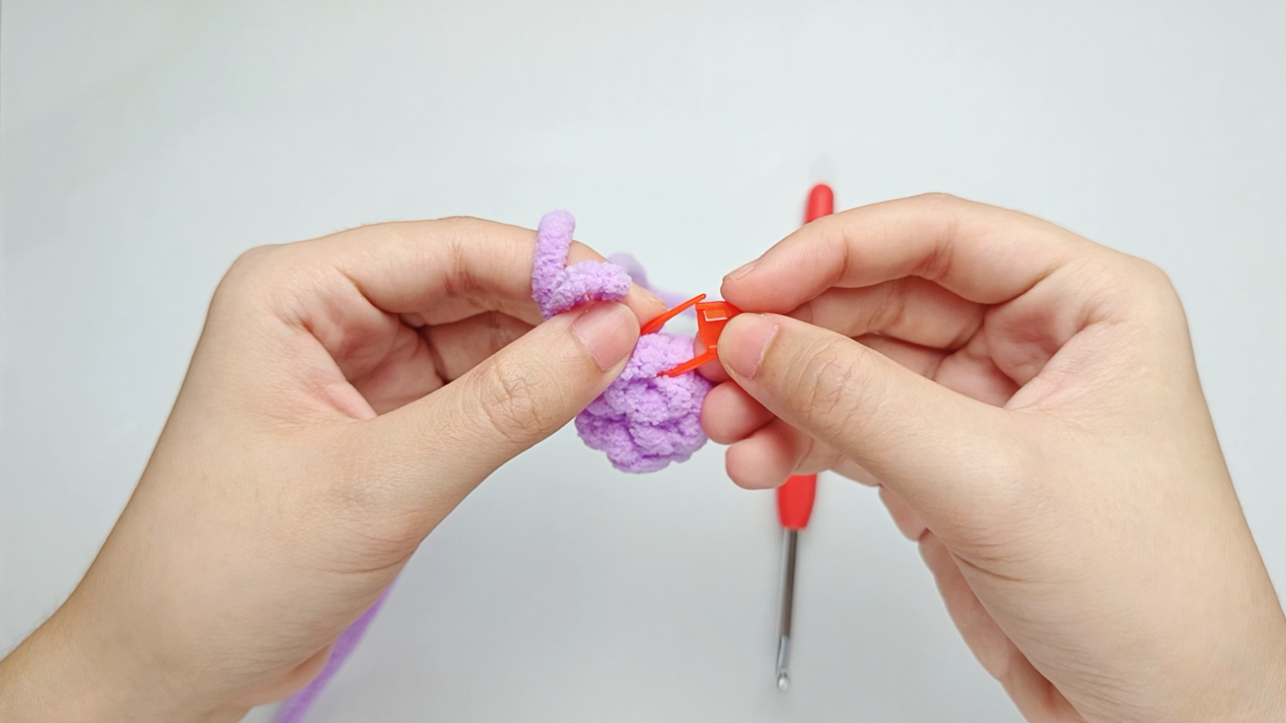 Mark the first stitch: Remove your hook for a moment, and use the stitch marker to mark this first stitch.