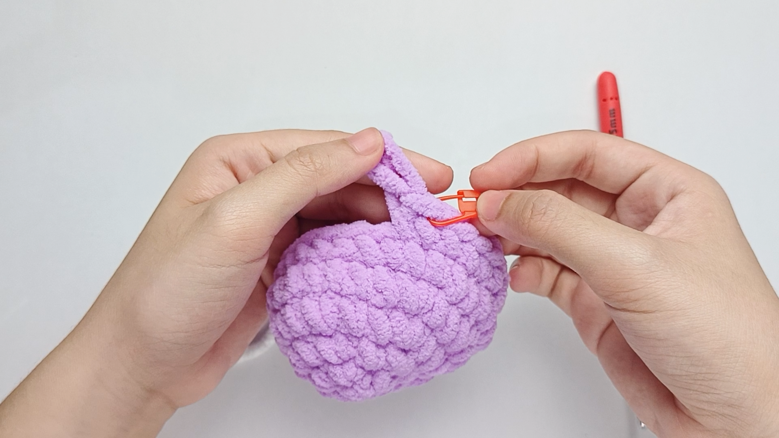 Mark the first stitch: Remove your hook for a moment, and use the stitch marker to mark this first stitch.