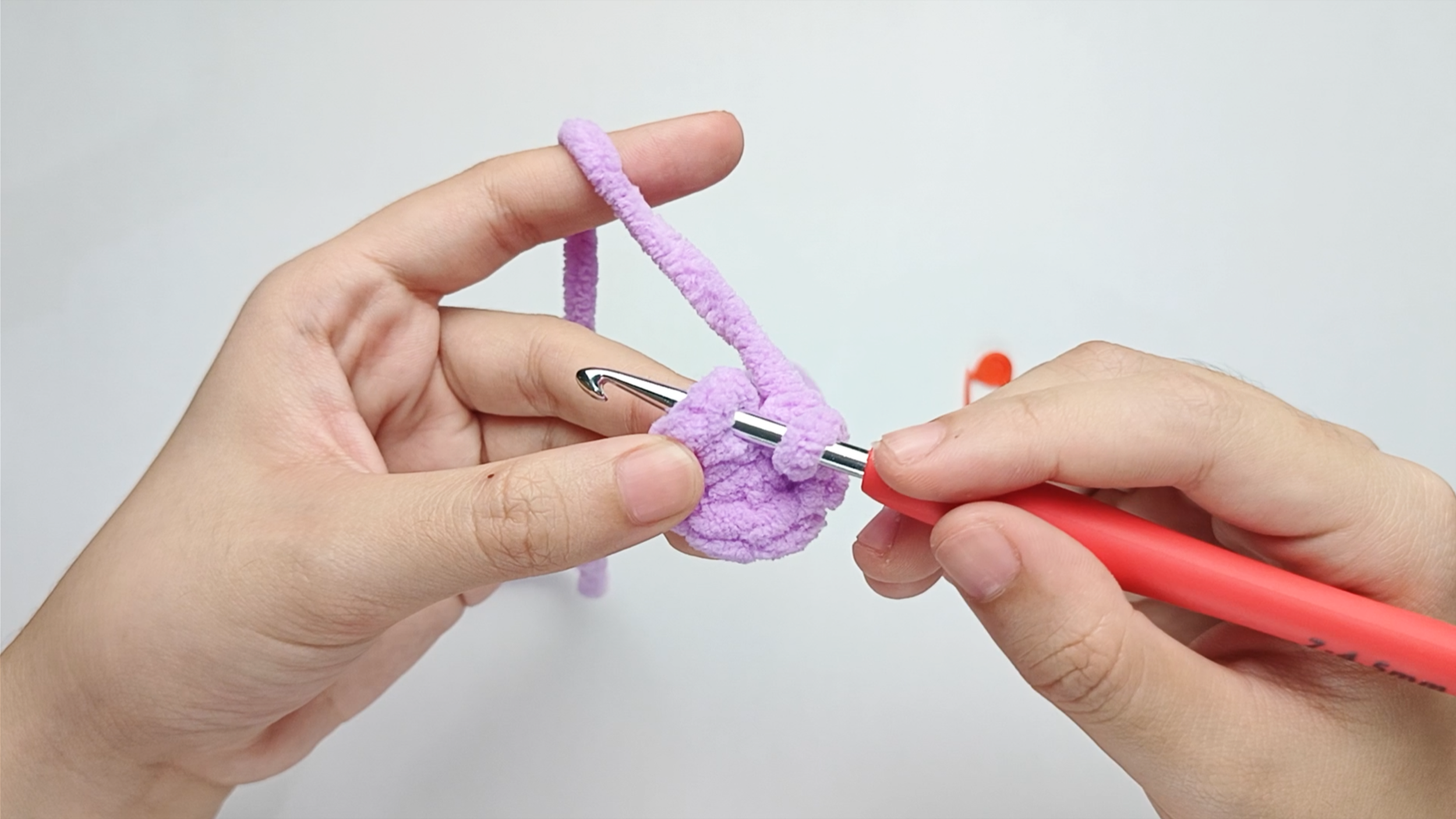 Hook back in: Insert your hook into that marked stitch to begin the next round. Remove the stitch marker so the stitch is easier to work into.