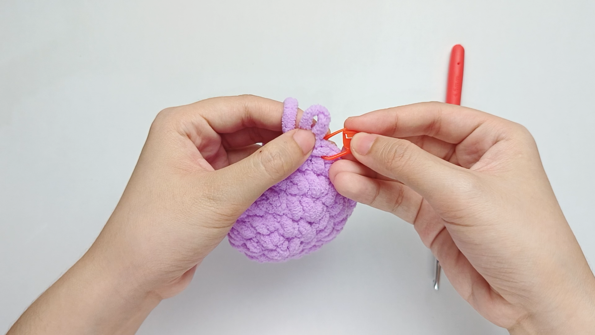 Mark the first stitch: Remove your hook for a moment, and use the stitch marker to mark this first stitch.