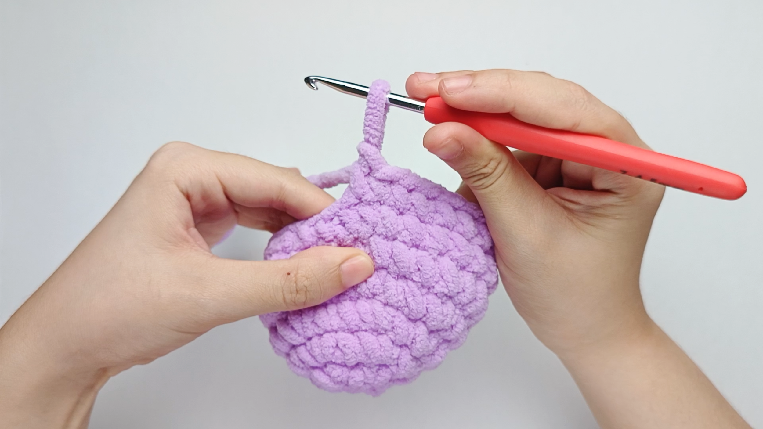 Make 1 single crochet (sc) first: Yarn over, pull through, yarn over again, and pull through both loops.