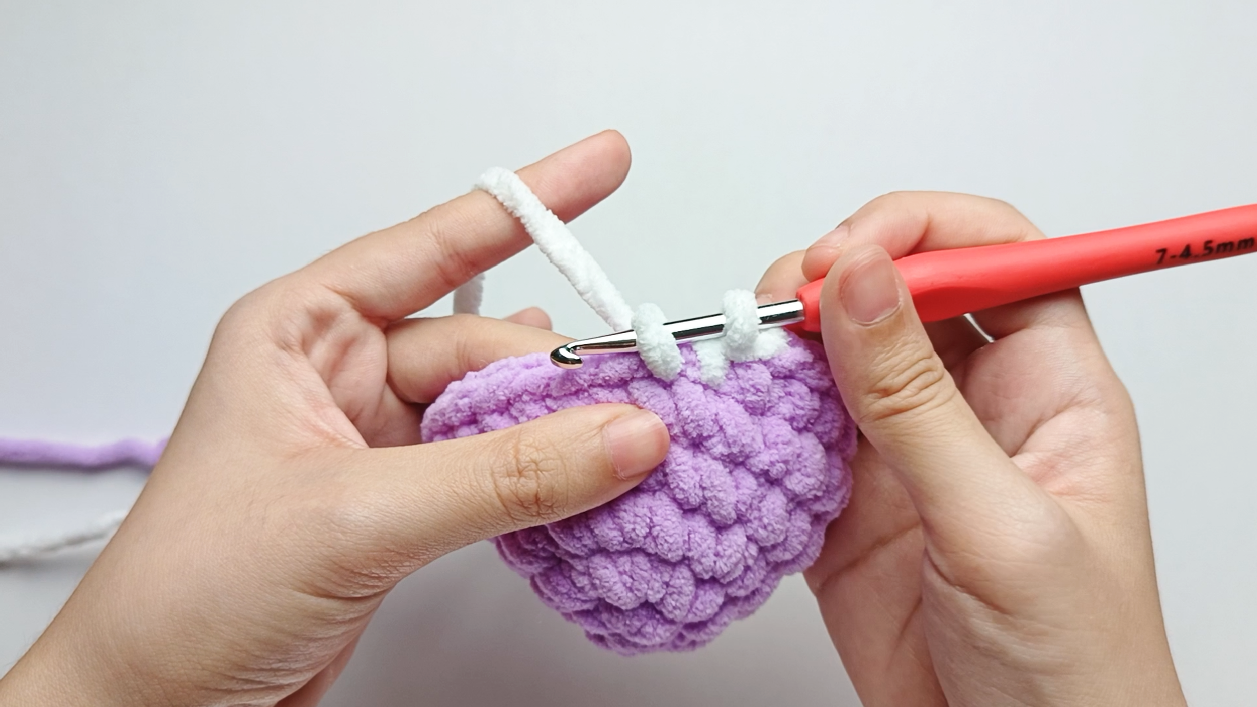 Make 2 white single crochets (sc): Color change to white, make 2 white single crochets (sc), and stop just before the final yarn over.
