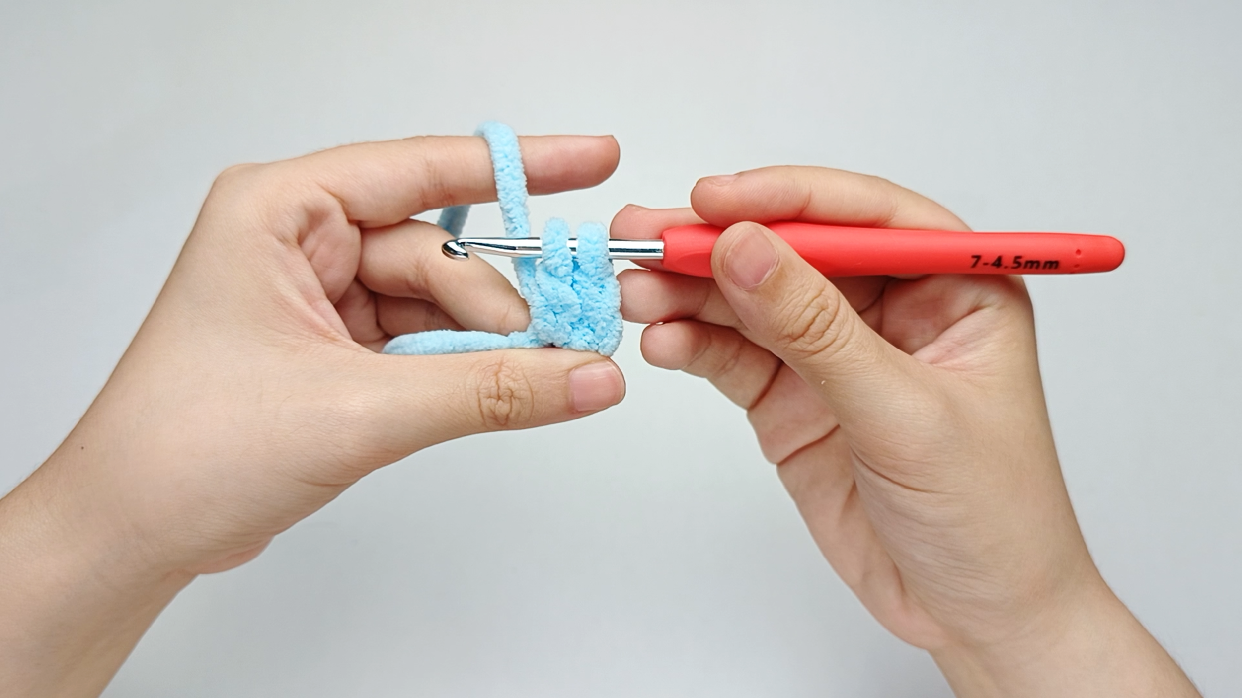 Pull through the first two loops: Pull the yarn through the first two loops on your hook. You should now have two loops left.