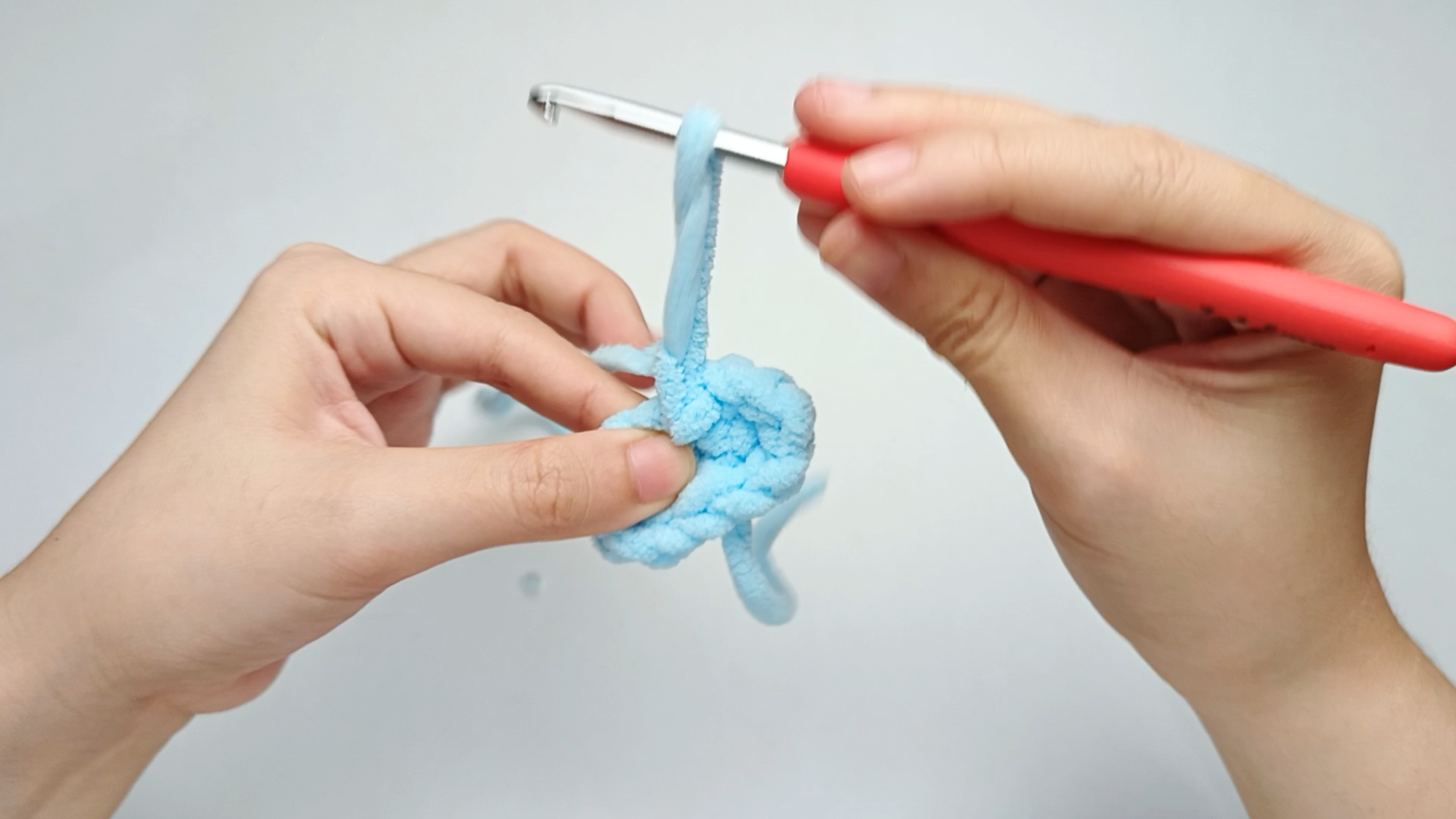 Yarn over and pull the yarn tail tight: Yarn over with the cut tail. Pull it all the way through that loop.