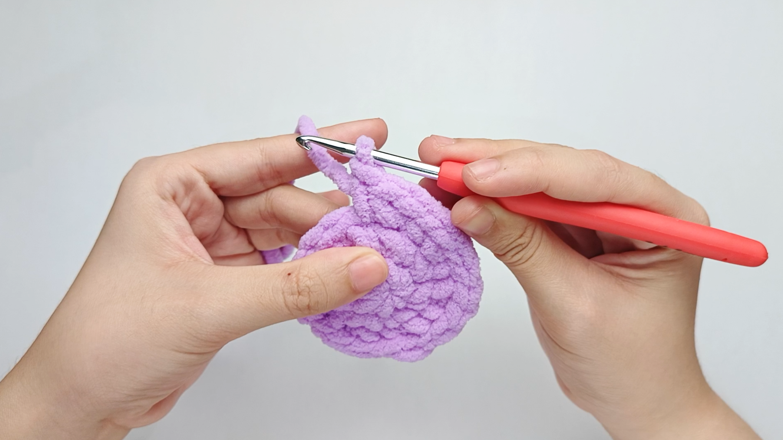 Make 1 single crochet (sc) first: Yarn over, pull through, yarn over again, and pull through both loops.