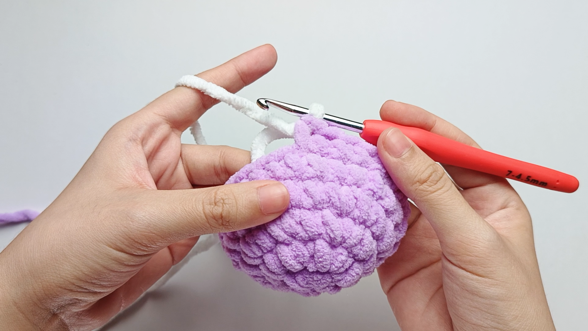 Color change to white: Pull the new white loop through the two purple loops. You should now have one loop of white on your hook. The color change is made.