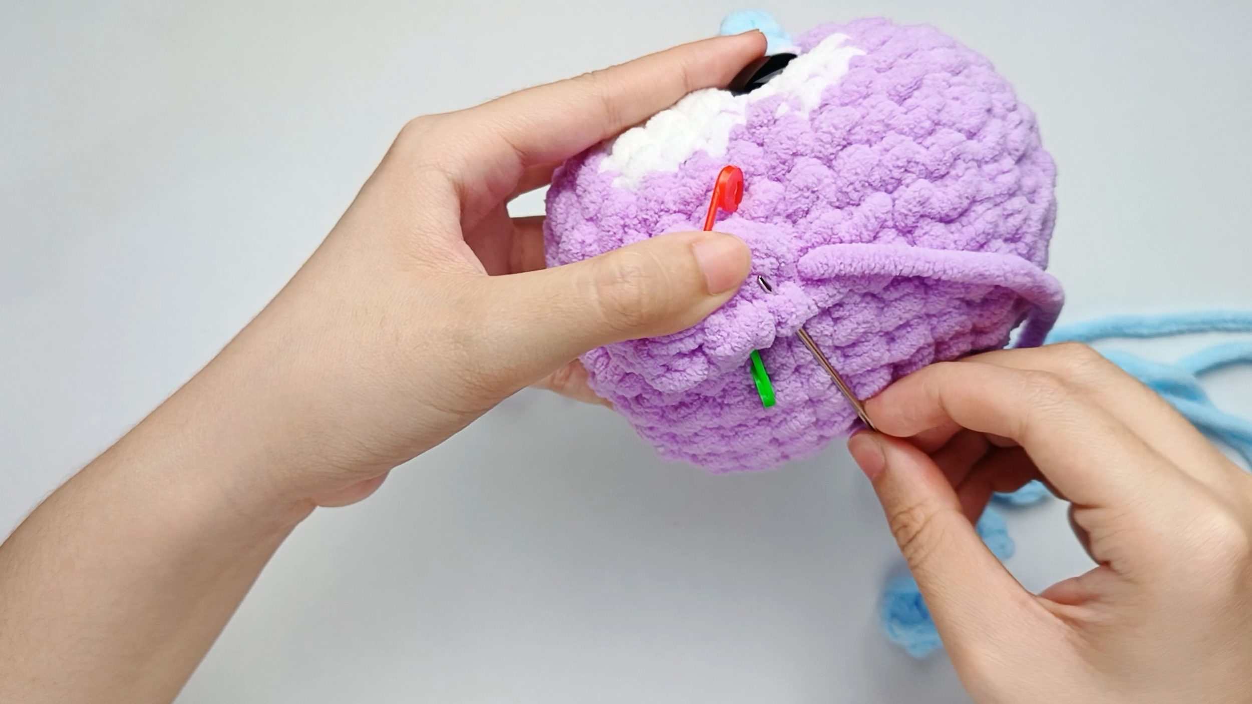 Up through the piece: Bring the needle up through one slip stitch (sl st) on the Wing. Pull the yarn all the way through.