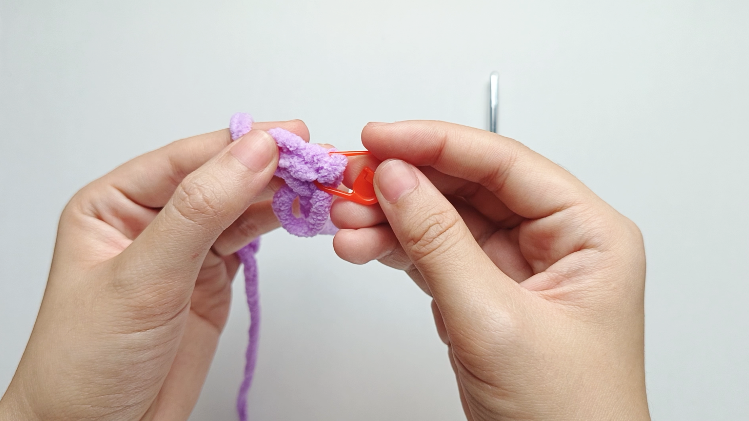 To find where the first stitch of the round begins, place a stitch marker through the first single crochet and lock it in place.