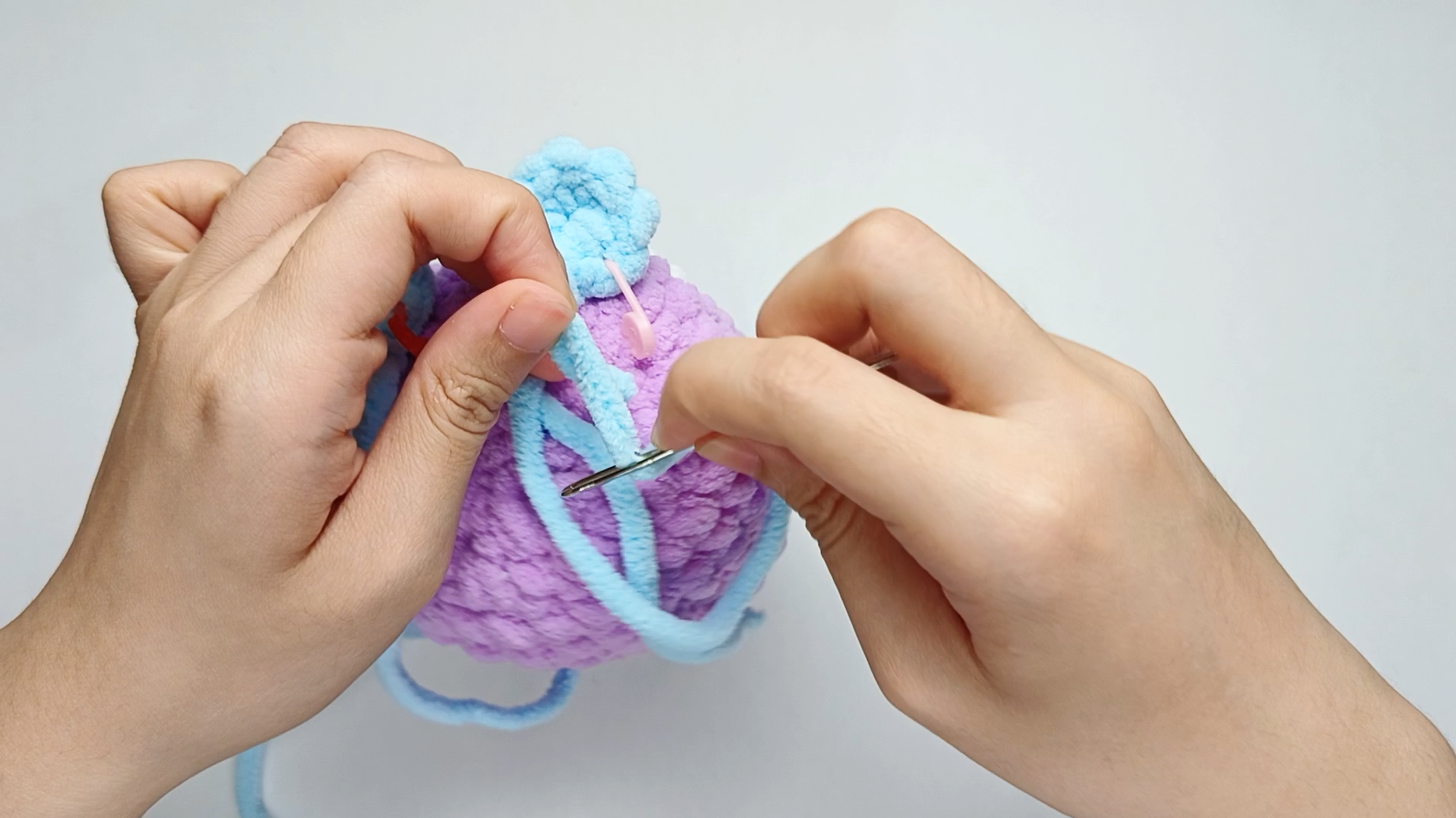 Thread the needle: Thread the yarn tail from the Foot onto your yarn needle.