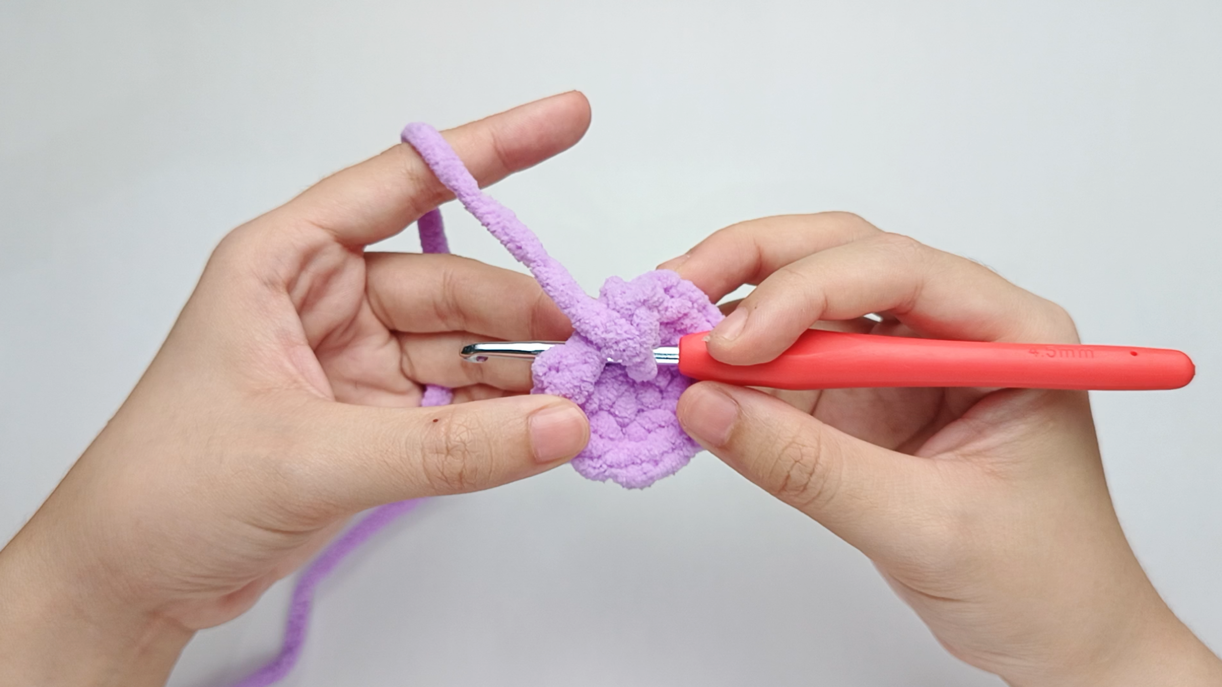 Hook back in: Insert your hook into that marked stitch to begin Round 3. Remove the stitch marker so the stitch is easier to work into.