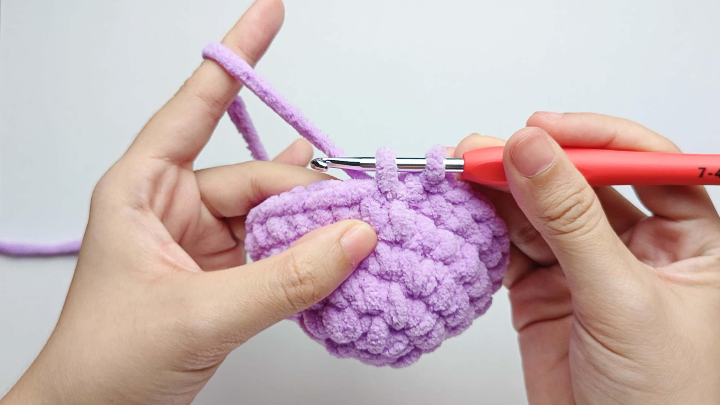 Make 9 more purple single crochets (sc): Repeat 1 single crochet (sc) in purple 9 more times. Yarn over, pull through, yarn over again, and pull through both loops.