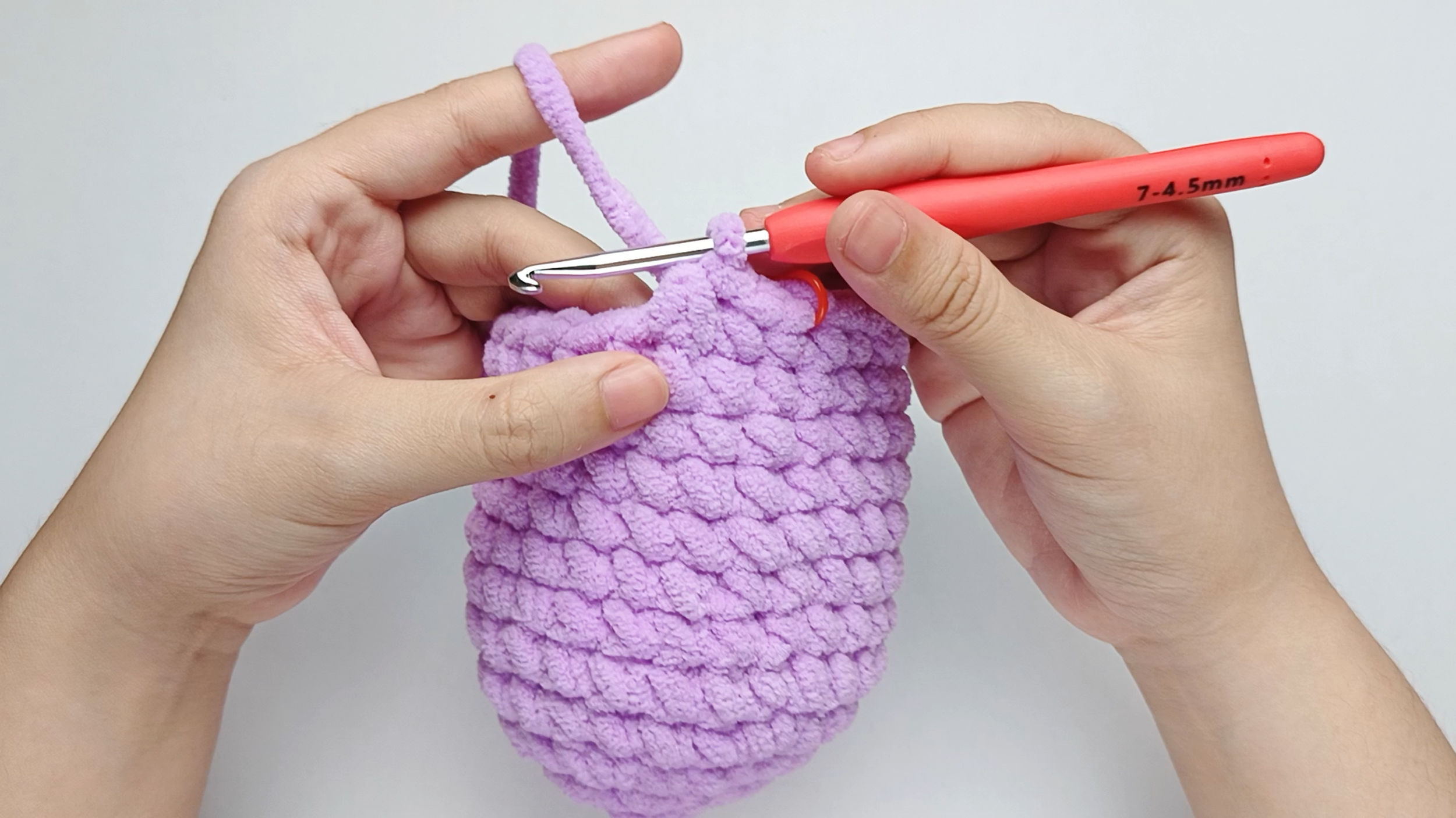 Pull through all three loops: Pull the yarn through all three loops.