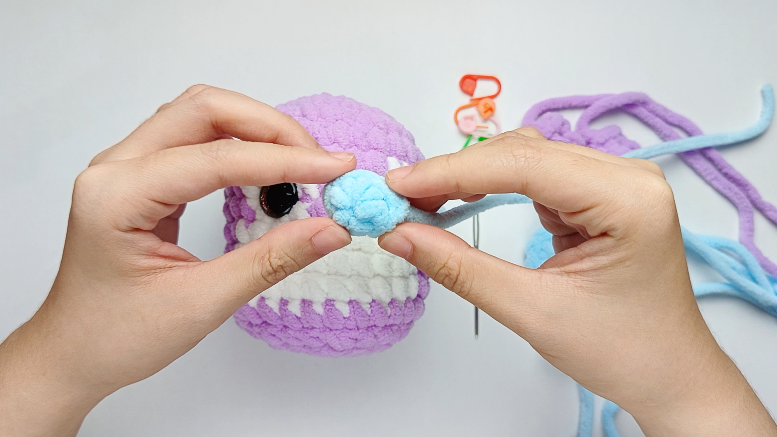 Fold the Nose: Fold the small circle in half so it lies flat, forming an oval shape.