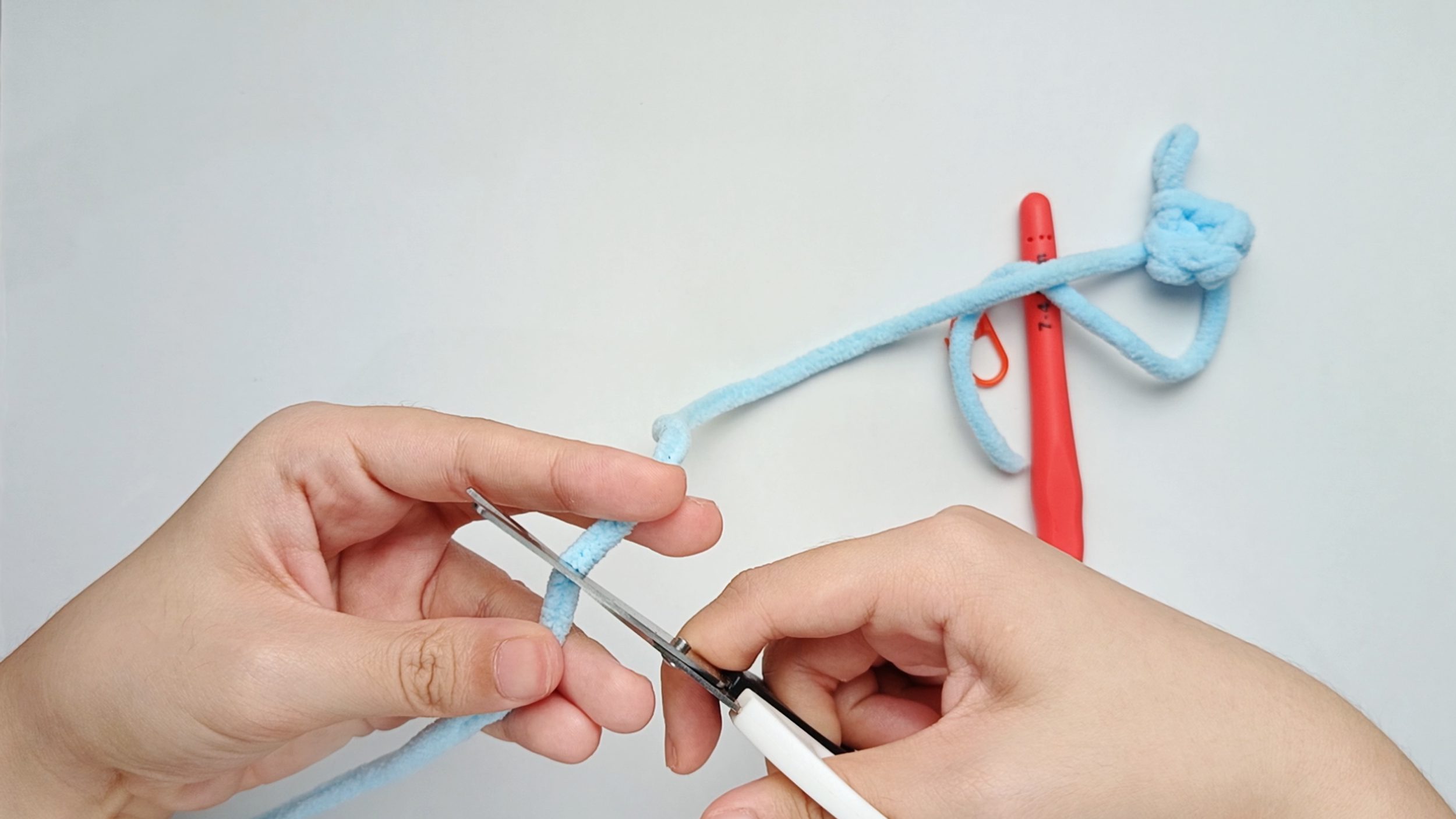 Fasten off (FO): Cut the yarn, leaving about a 6-inch tail. You’ll use this yarn tail later to sew the Nose onto the Body.