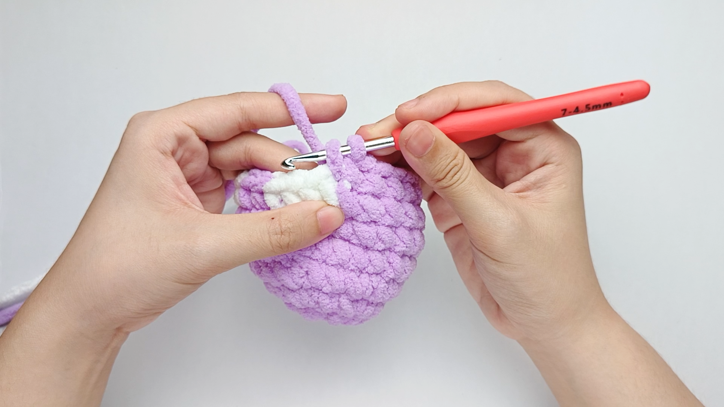 Make 9 more purple single crochets (sc): Repeat 1 single crochet (sc) in purple 9 more times. Stop just before the final yarn over.
