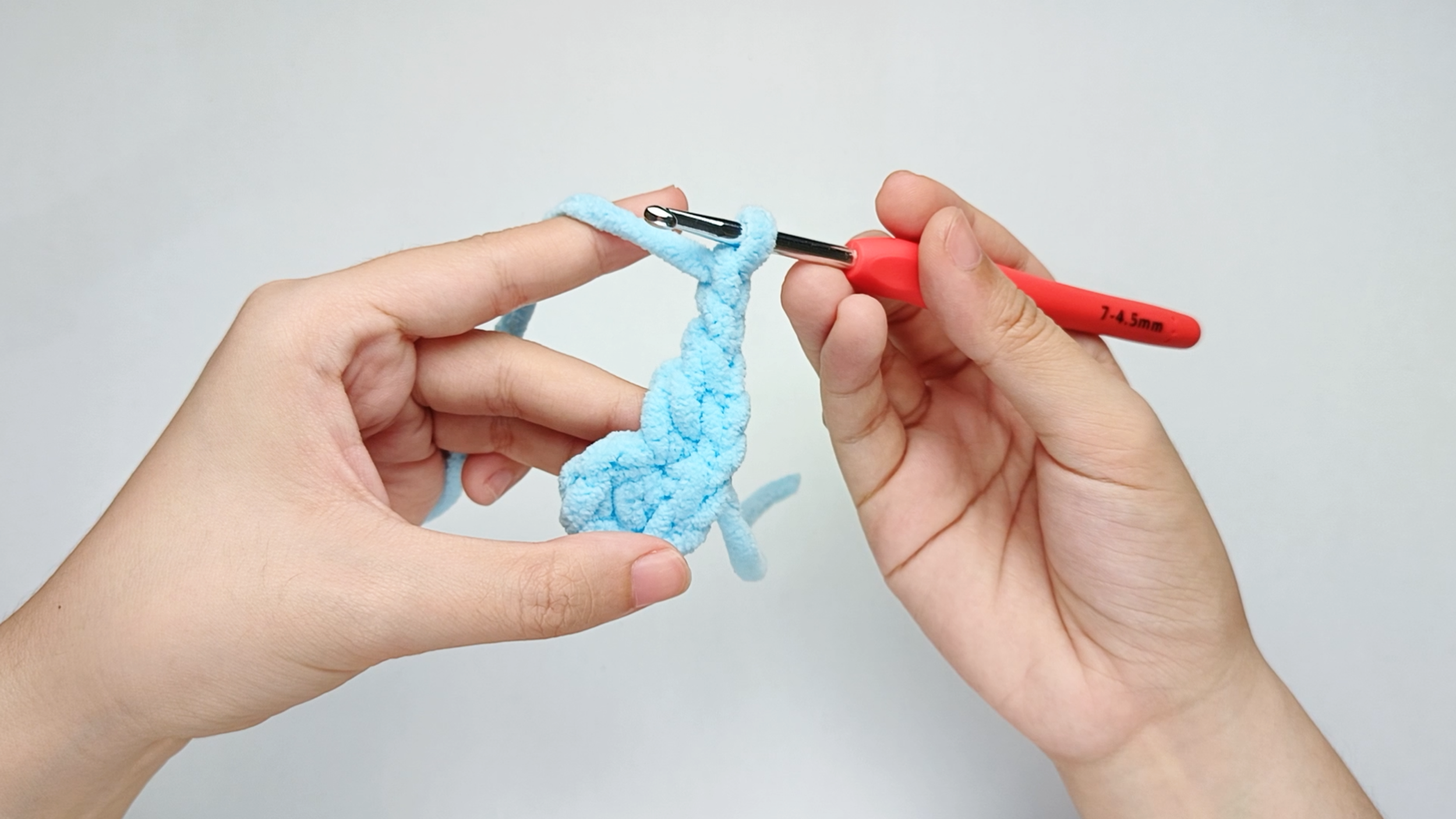 Make chain 2 (ch): Yarn over and pull through the loop on your hook, then do the same once more.