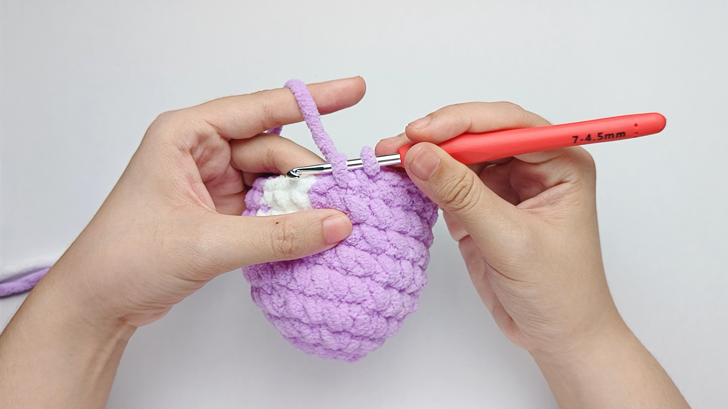 Make 8 more purple single crochets (sc): Repeat 1 single crochet (sc) in purple 8 more times. Stop just before the final yarn over.