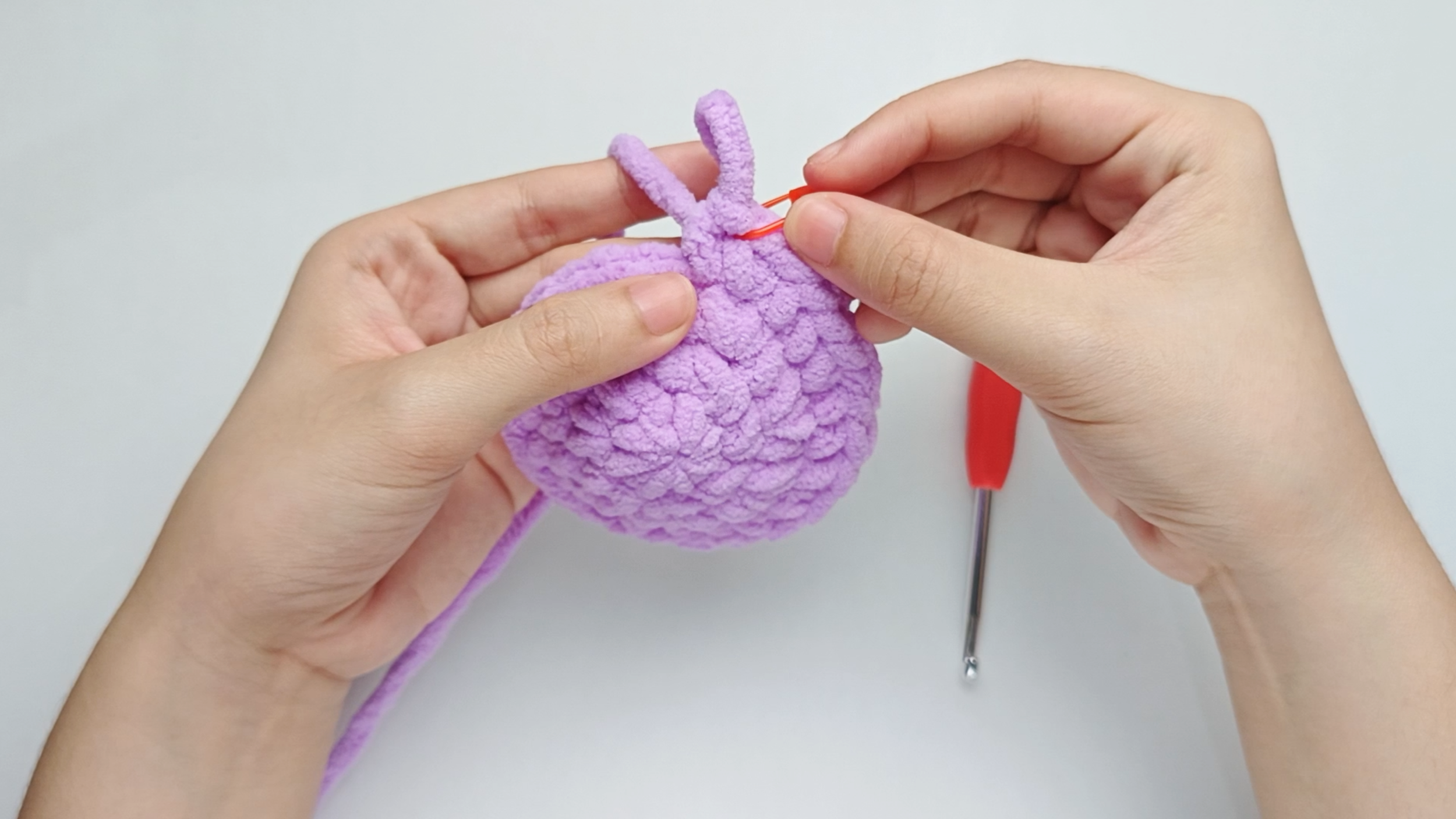 Mark the first stitch: Remove your hook for a moment, and use the stitch marker to mark this first stitch.