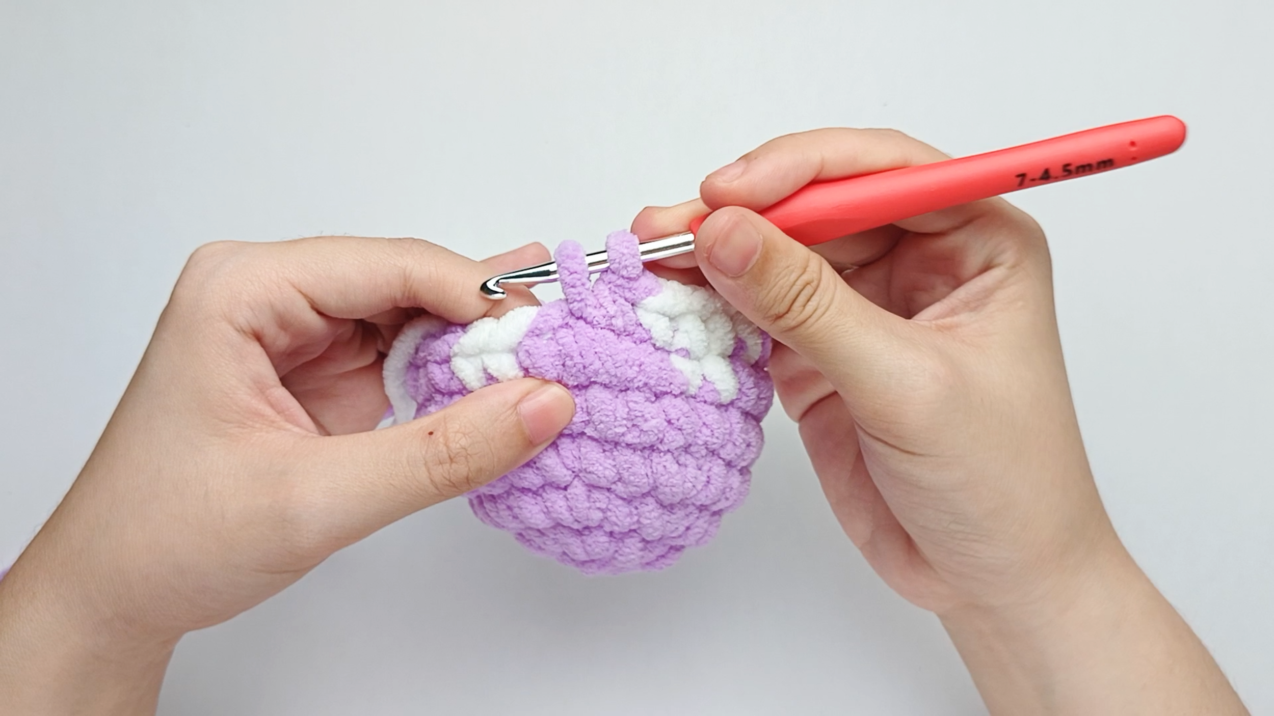 Make 2 purple single crochets (sc): Color change to purple, make 2 purple single crochets (sc), and stop just before the final yarn over.