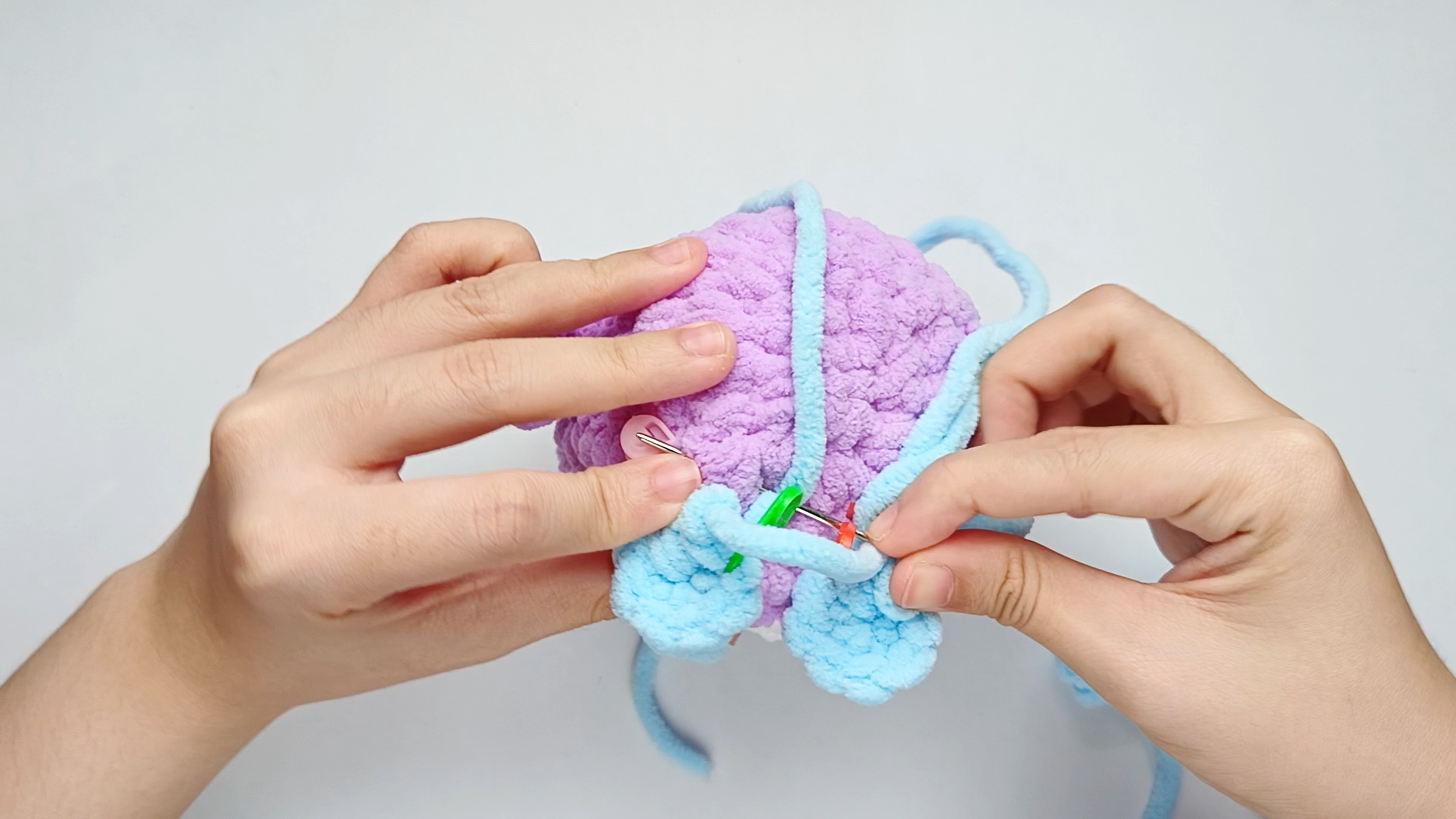 Into the Body: Insert the needle into one stitch of the Body, lining it up with the next stitch on the piece. Pull the yarn all the way through.