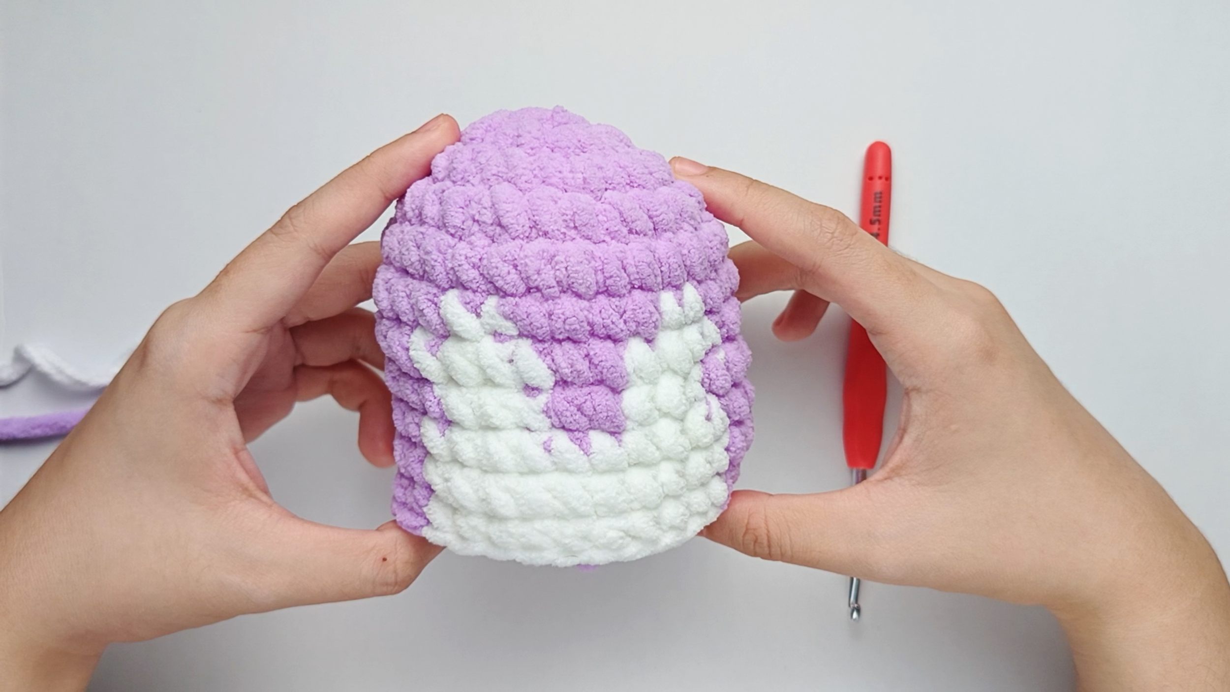 Completed Round 9, 10, and 11: Here, we have made single crochets (sc) for 9 purple, 10 white, and 9 purple for 3 rounds. In each round, there should be 28 stitches in total..