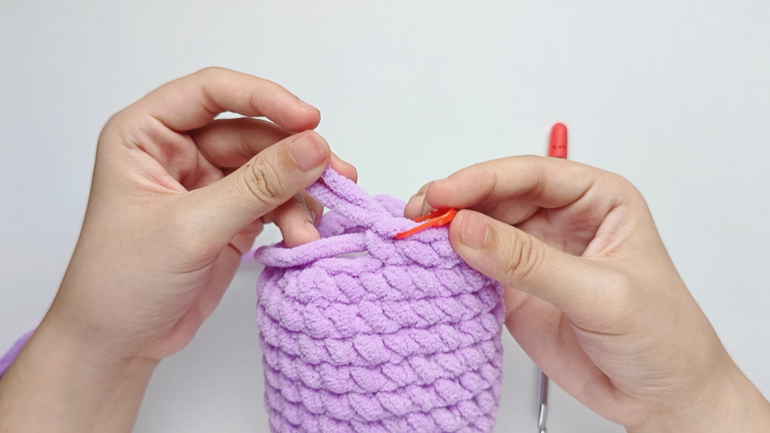 Mark the first stitch: Remove your hook for a moment, and use the stitch marker to mark this first stitch.