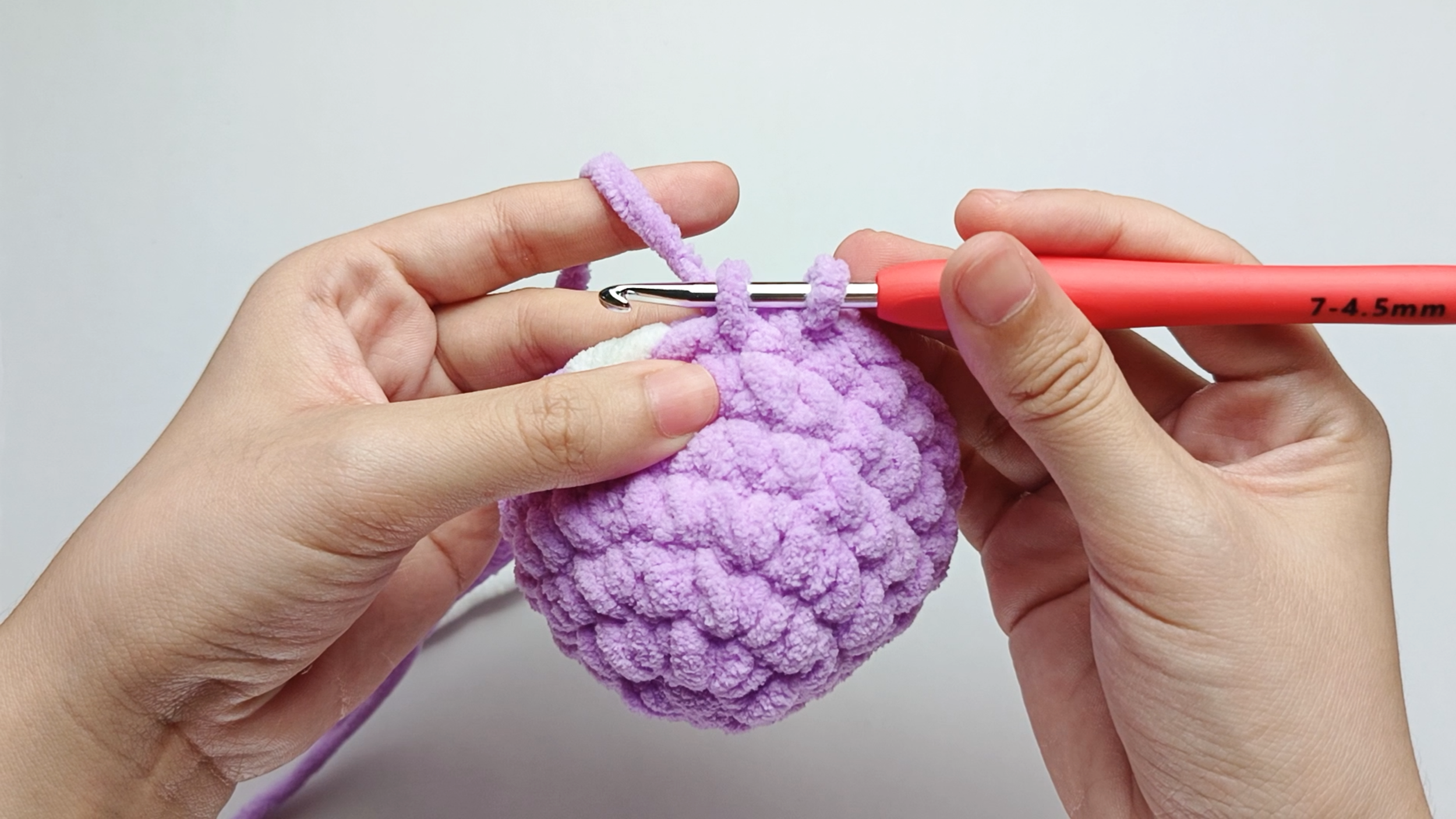 Make 8 more purple single crochets (sc): Repeat 1 single crochet (sc) in purple 8 more times. Stop just before the final yarn over.