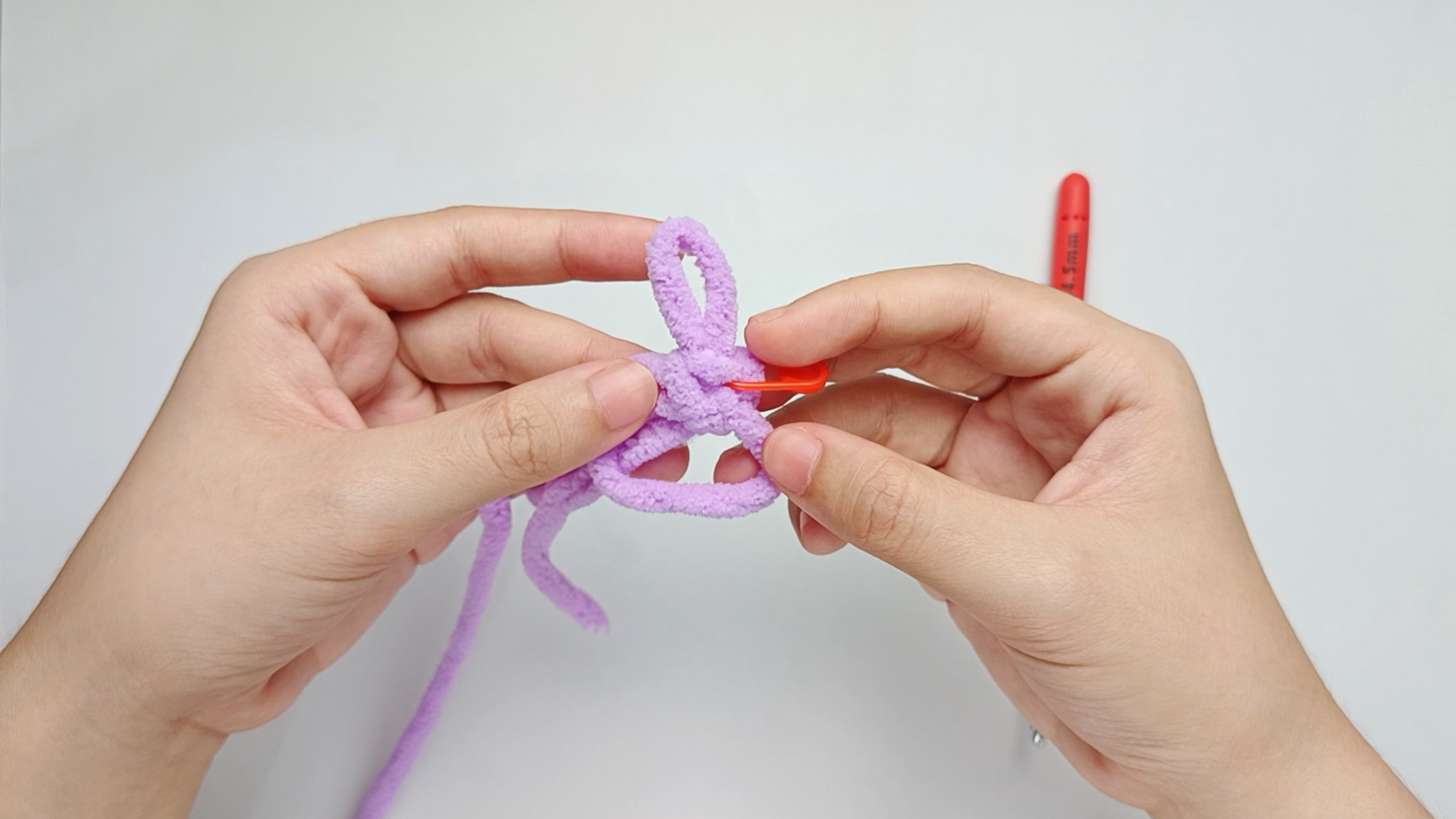 Mark the first stitch: Remove your hook for a moment, and use the stitch marker to mark this first stitch.