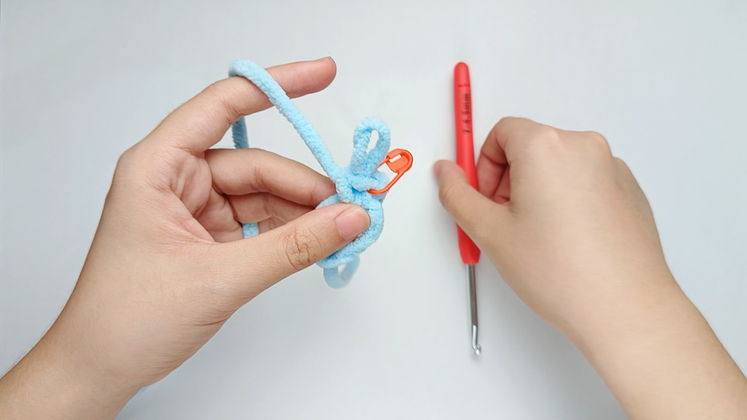 Mark the first stitch: Remove your hook for a moment, and use the stitch marker to mark this first stitch.